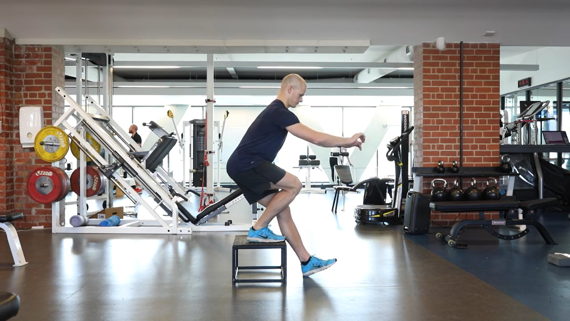 ACL recovery exercise: one foot on stool squatting exercise.