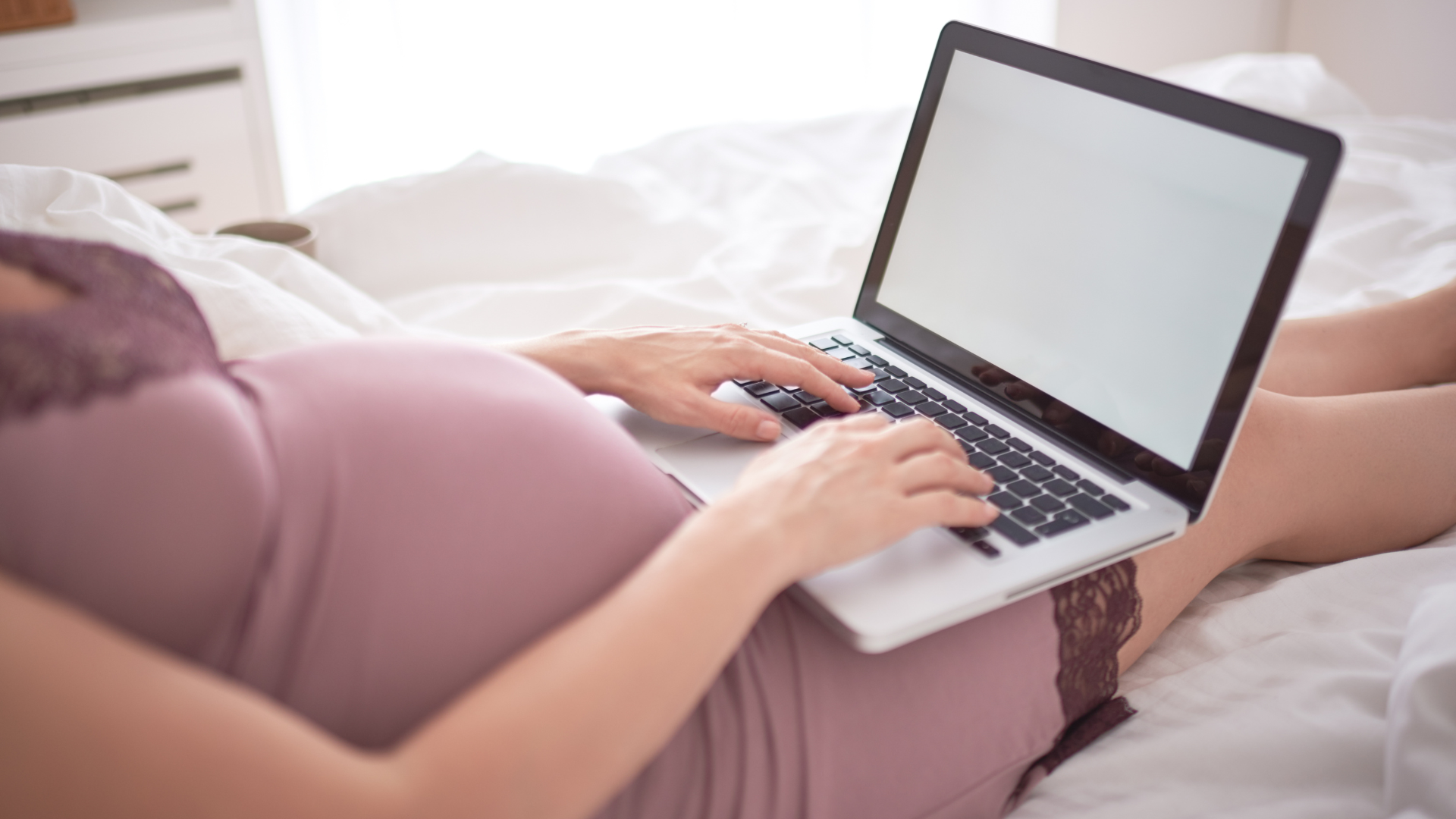 pregnant body typing on computer