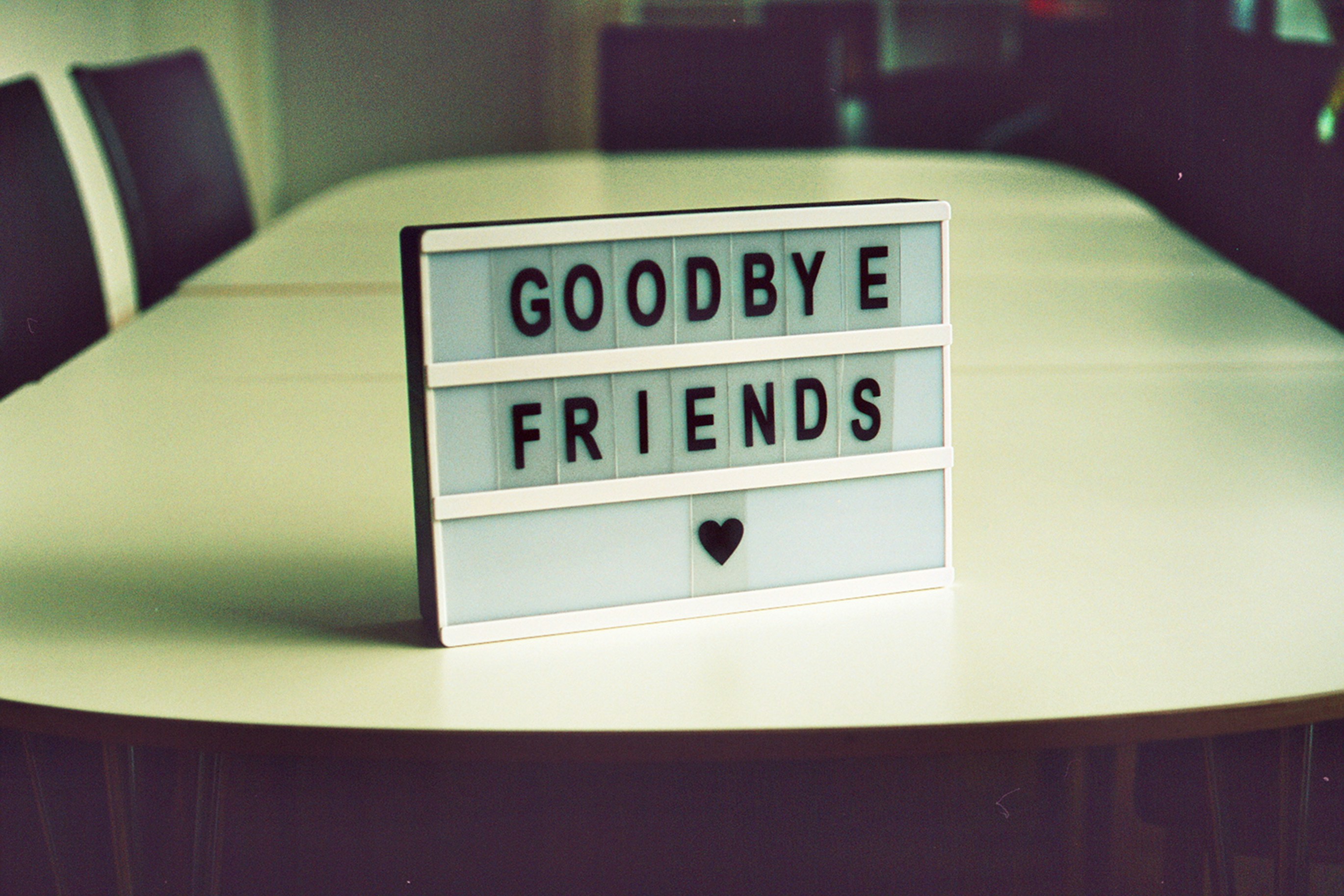 Goodbye Friends sign on a conference table