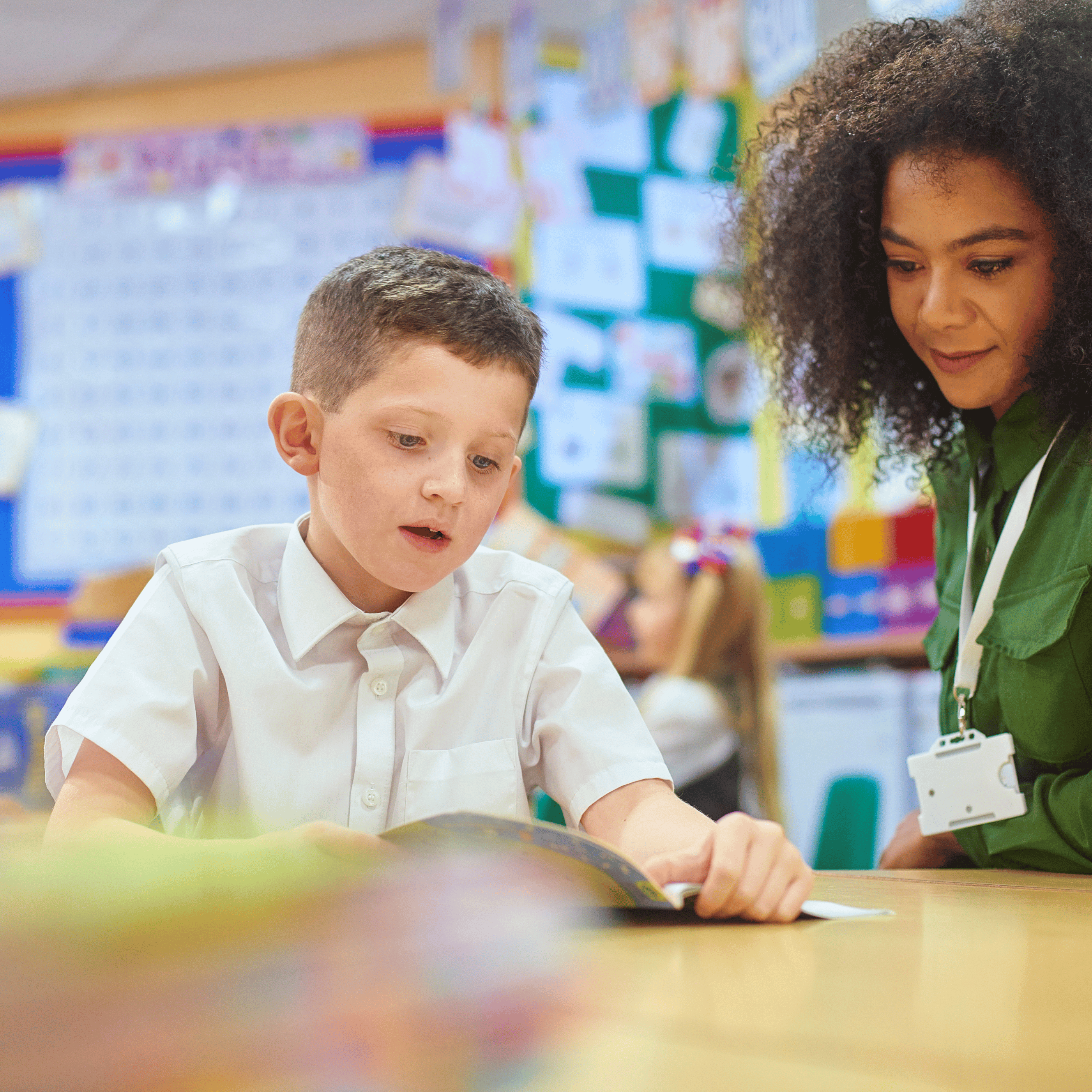 boy reading to a teacher