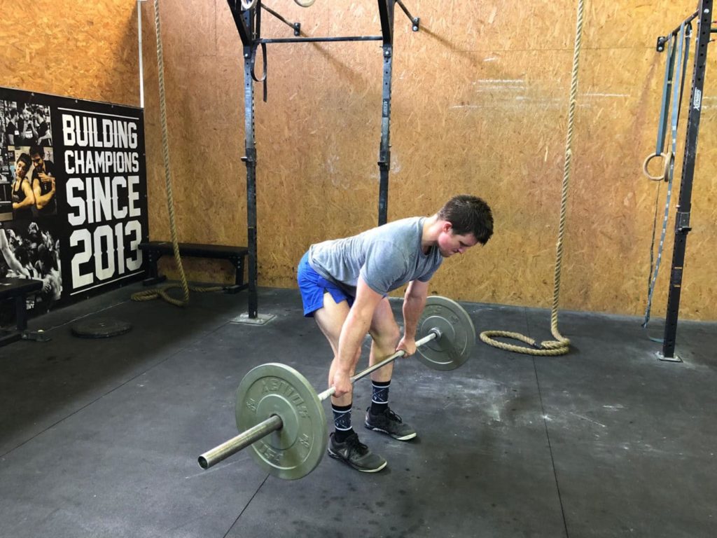 Man performing nordic hamstring curls and straight-legged deadlifts for injury prevention and ACL and hamstring rehabilitation.