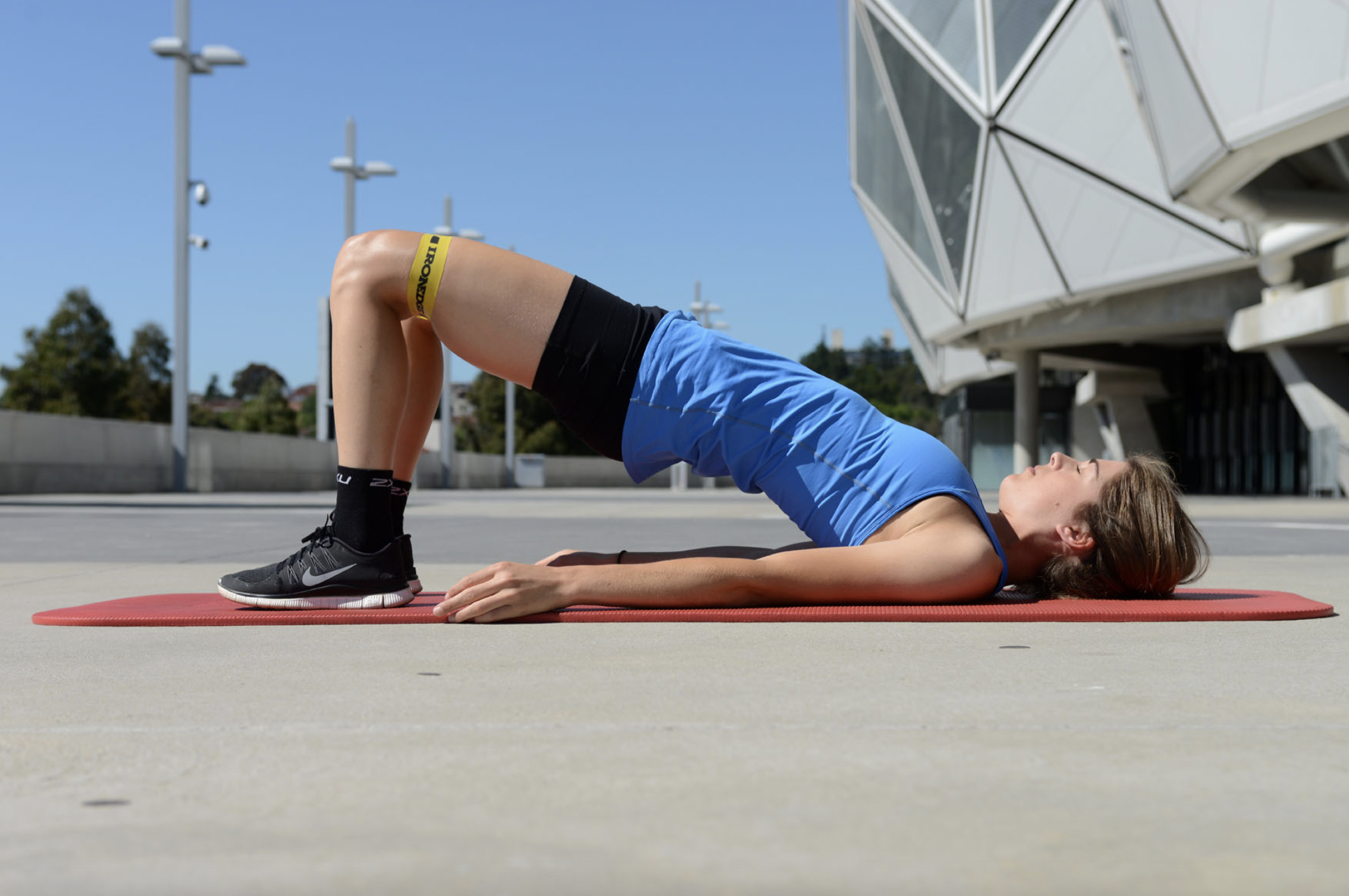 Woman doing hip Extension exercises to help with partial ACL tear recovery.
