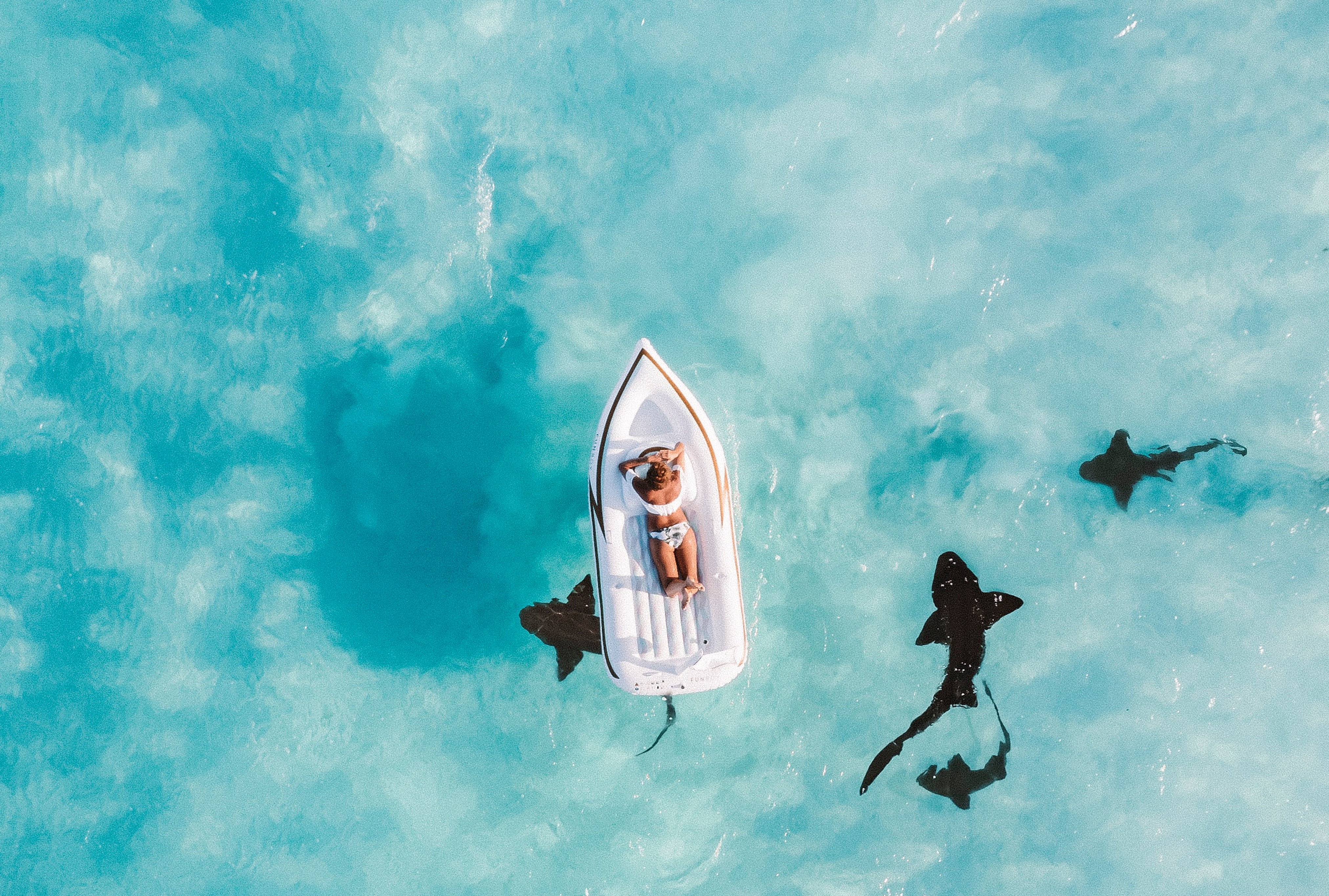 woman in boat in crystal clear water