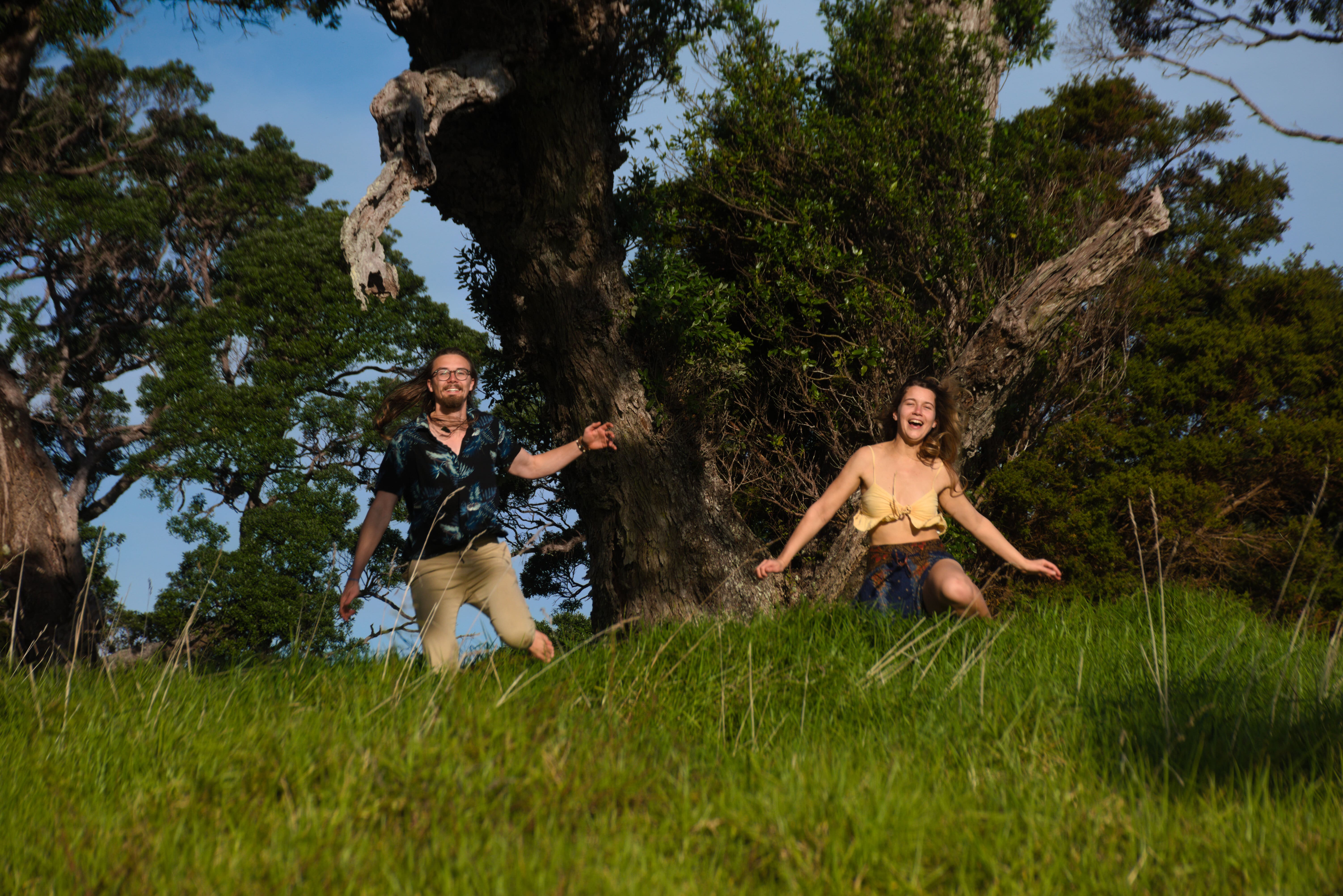 Ema&Kristjan on the running with trees in the background.