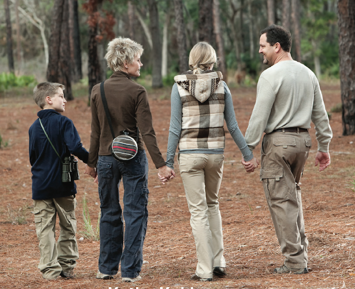 family walking in the woods