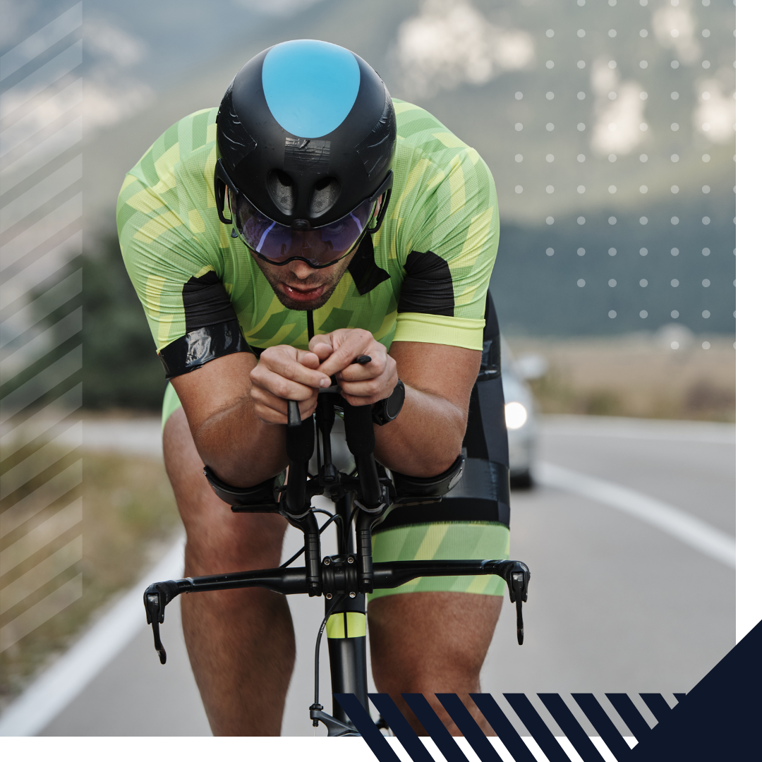 Photo of a triathlete on a bike wearing a green jersey.