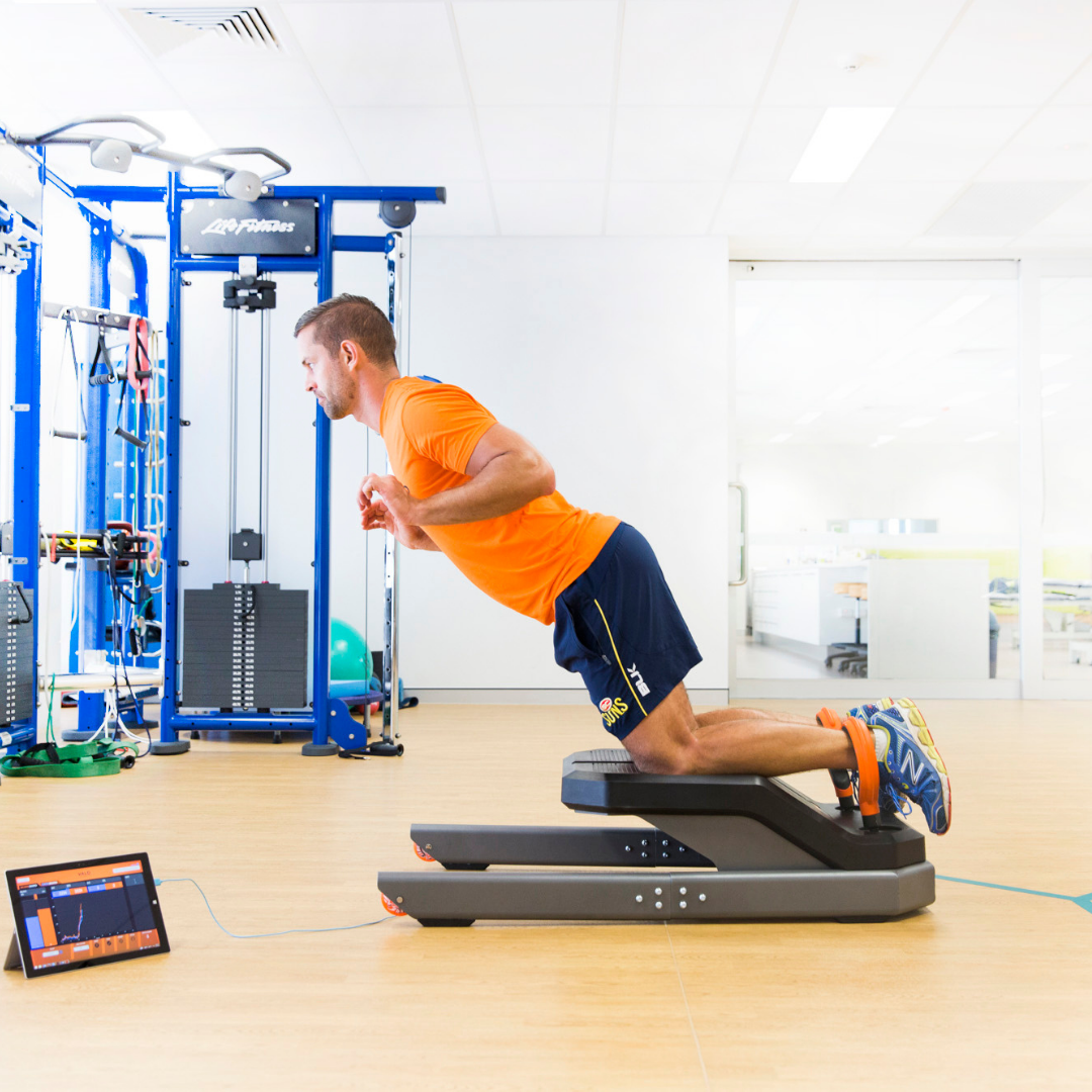 Man performing exercise for hamstring injury recovery.