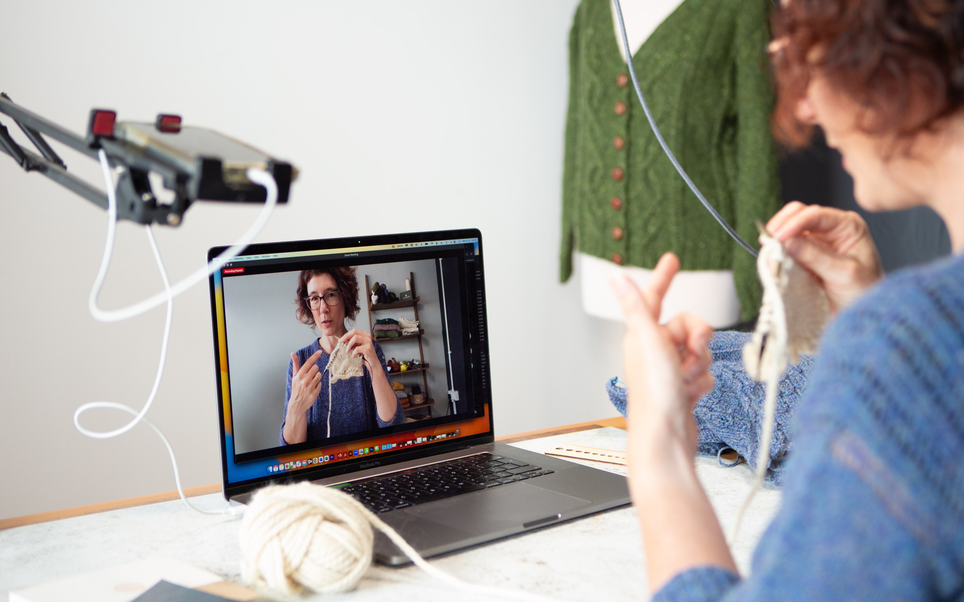 Carol knitting with mobile phone and laptop