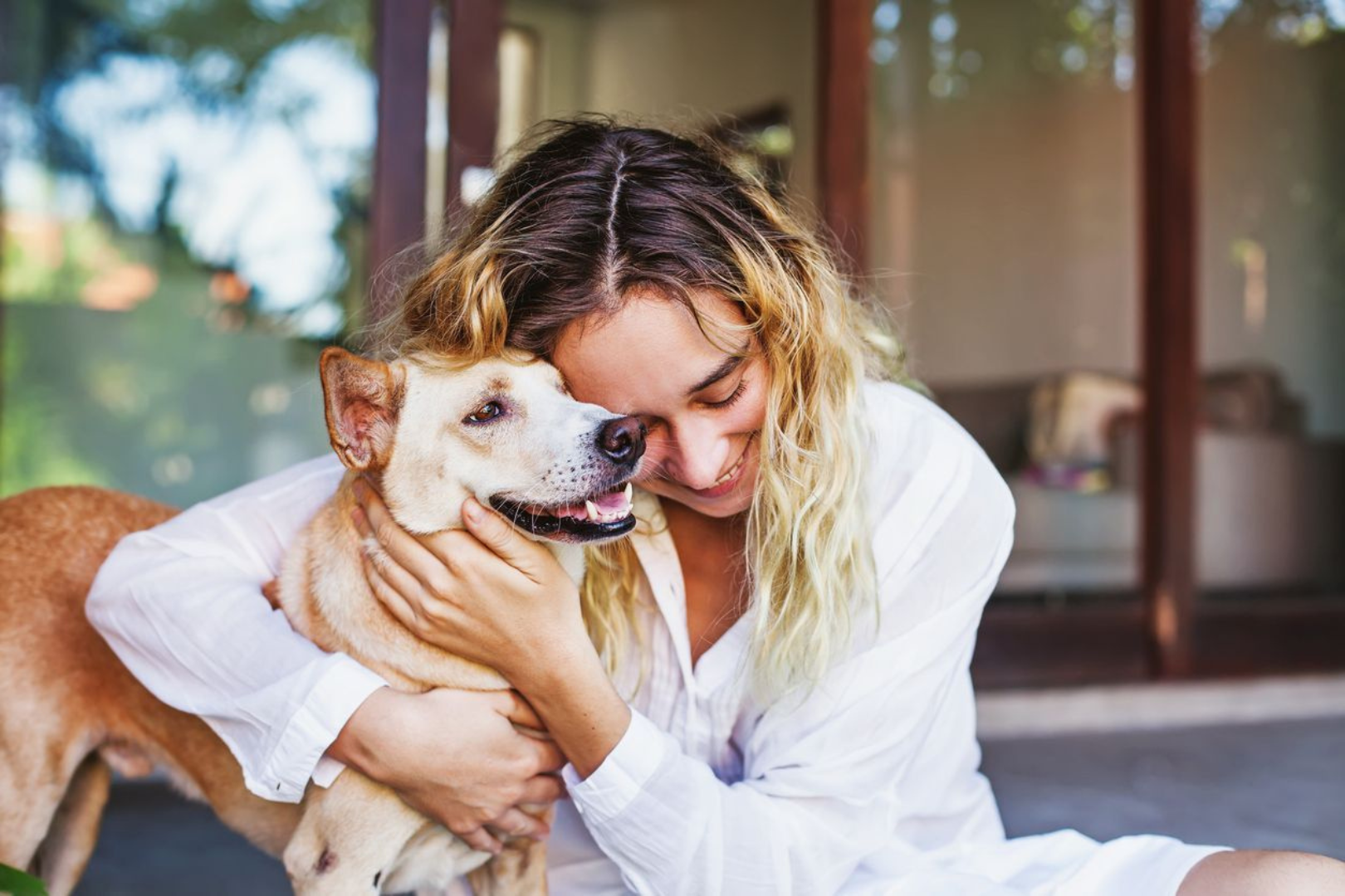 Woman hugging senior dog