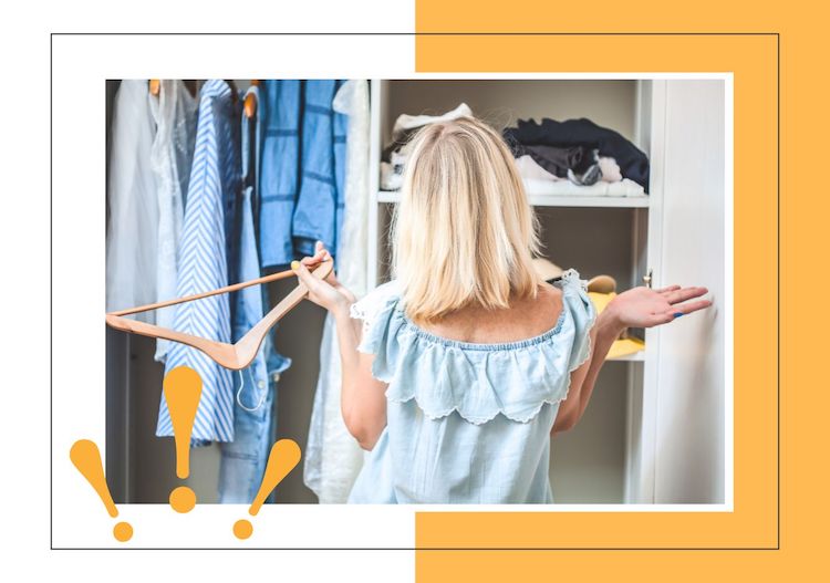 woman holding up her hands while standing in front of her closet