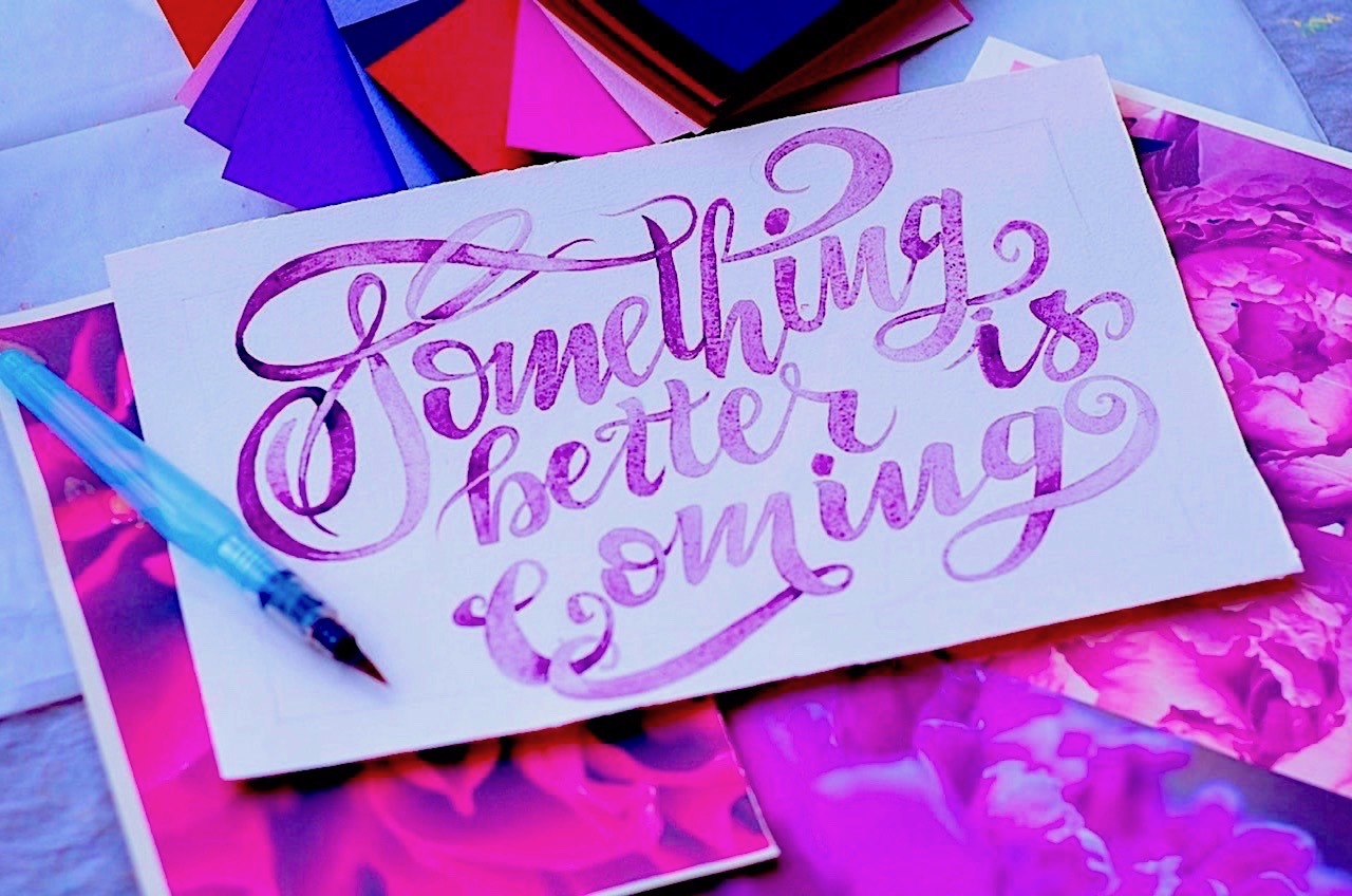 A piece of card with &#39;Something better is coming&#39; written on it