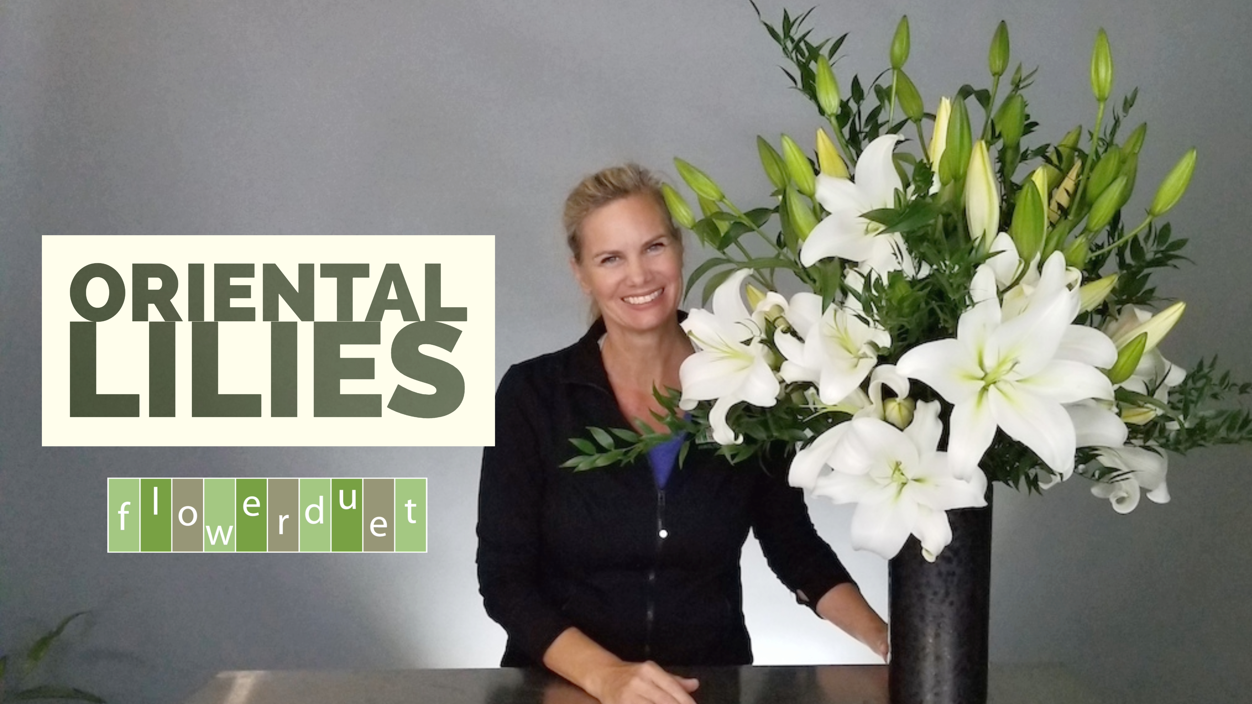 Kit with White Oriental Lilies in a Black Vase 