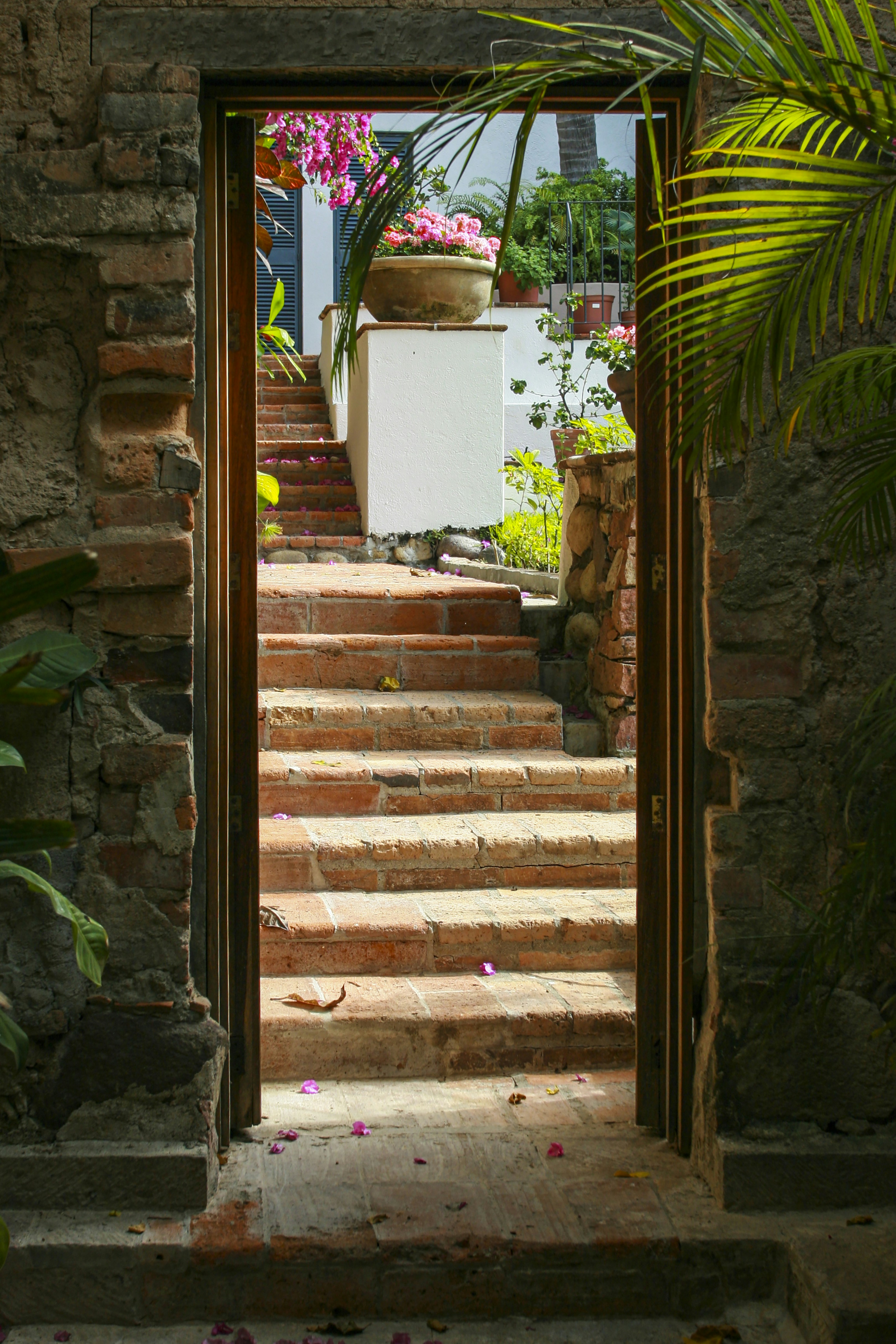 Doorway leading to brick stairs that are going up 