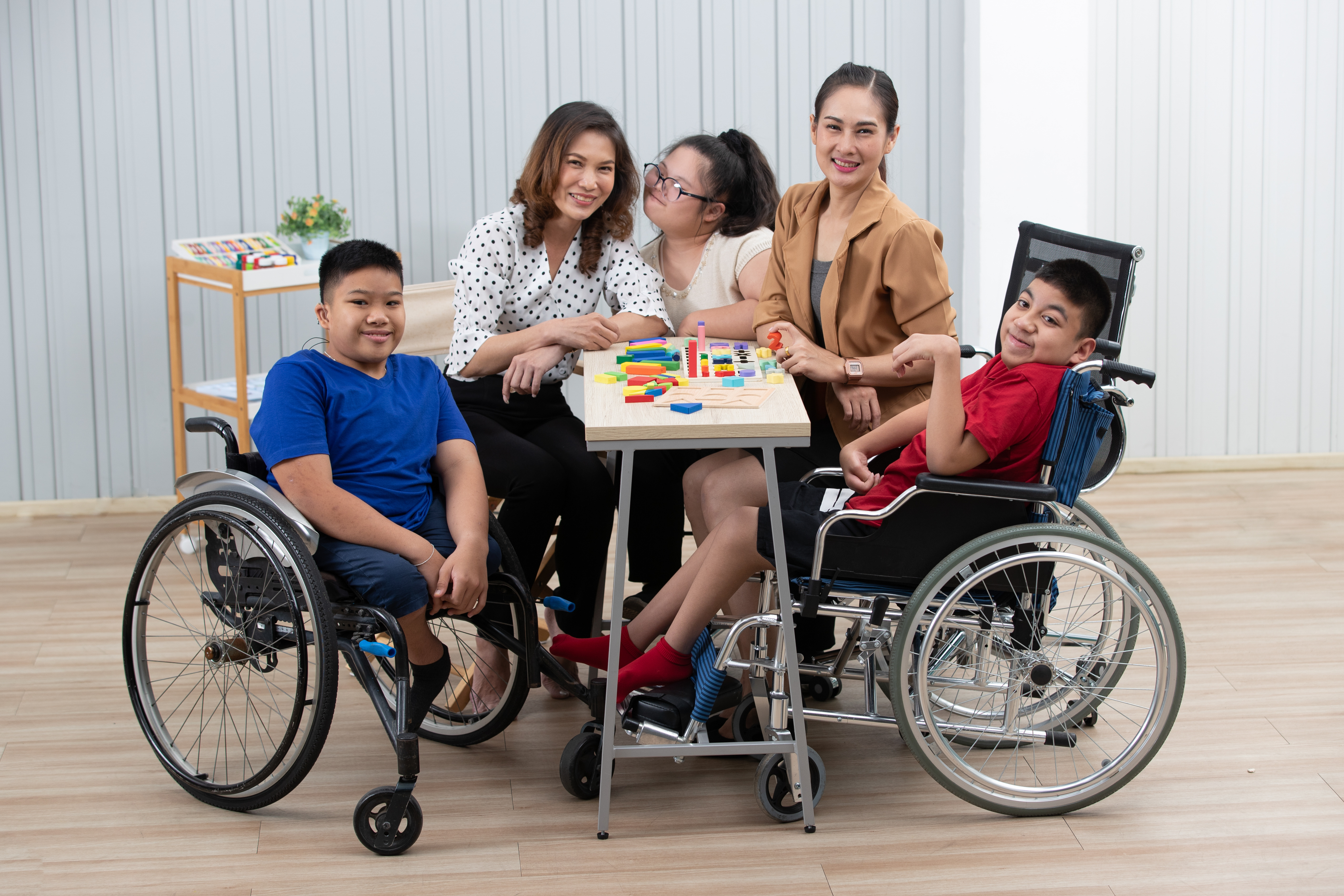 2 students in a wheelchair with 2 teachers