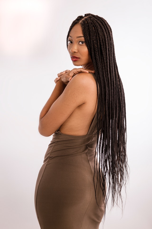 lady in brown dress with long braids