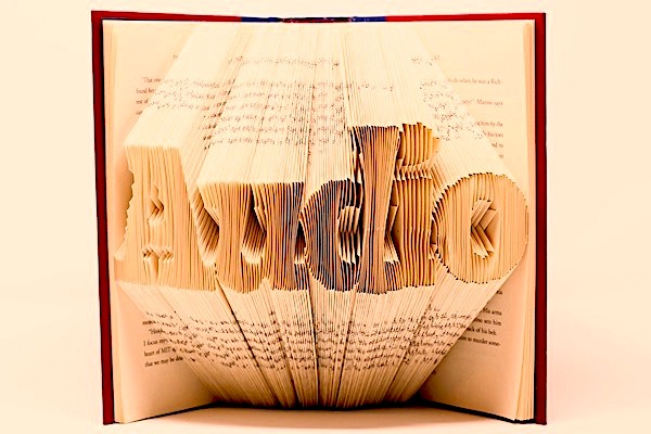 Book with pages folded in such a way that they spell the word &#39;Audio&#39;