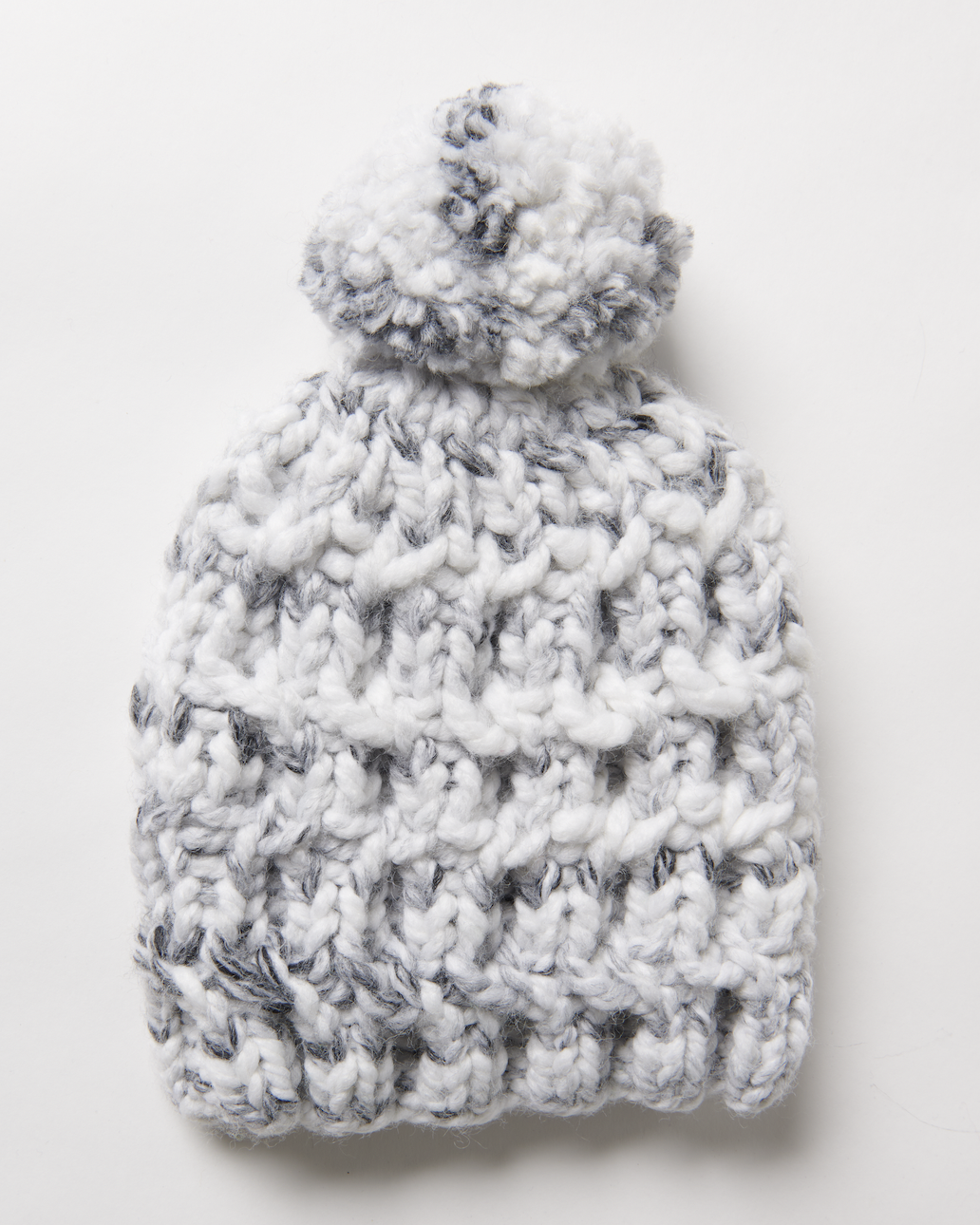 chunky cabled hat with a pom on top