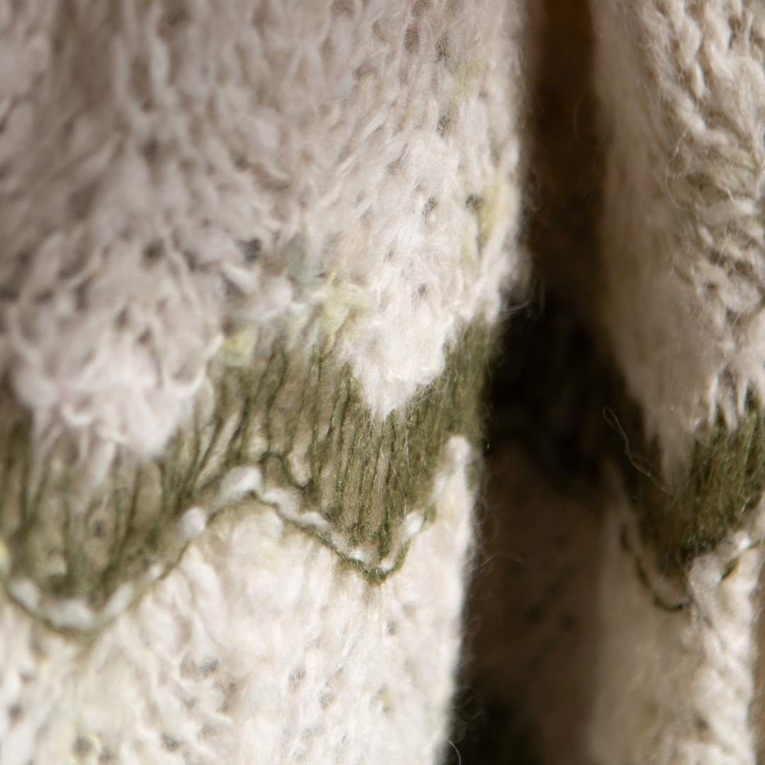 Up close image of the wave pattern on the body of the sweater.