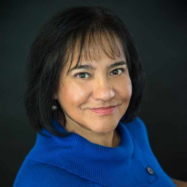 Rosalba in a blue sweater smiling at the camera