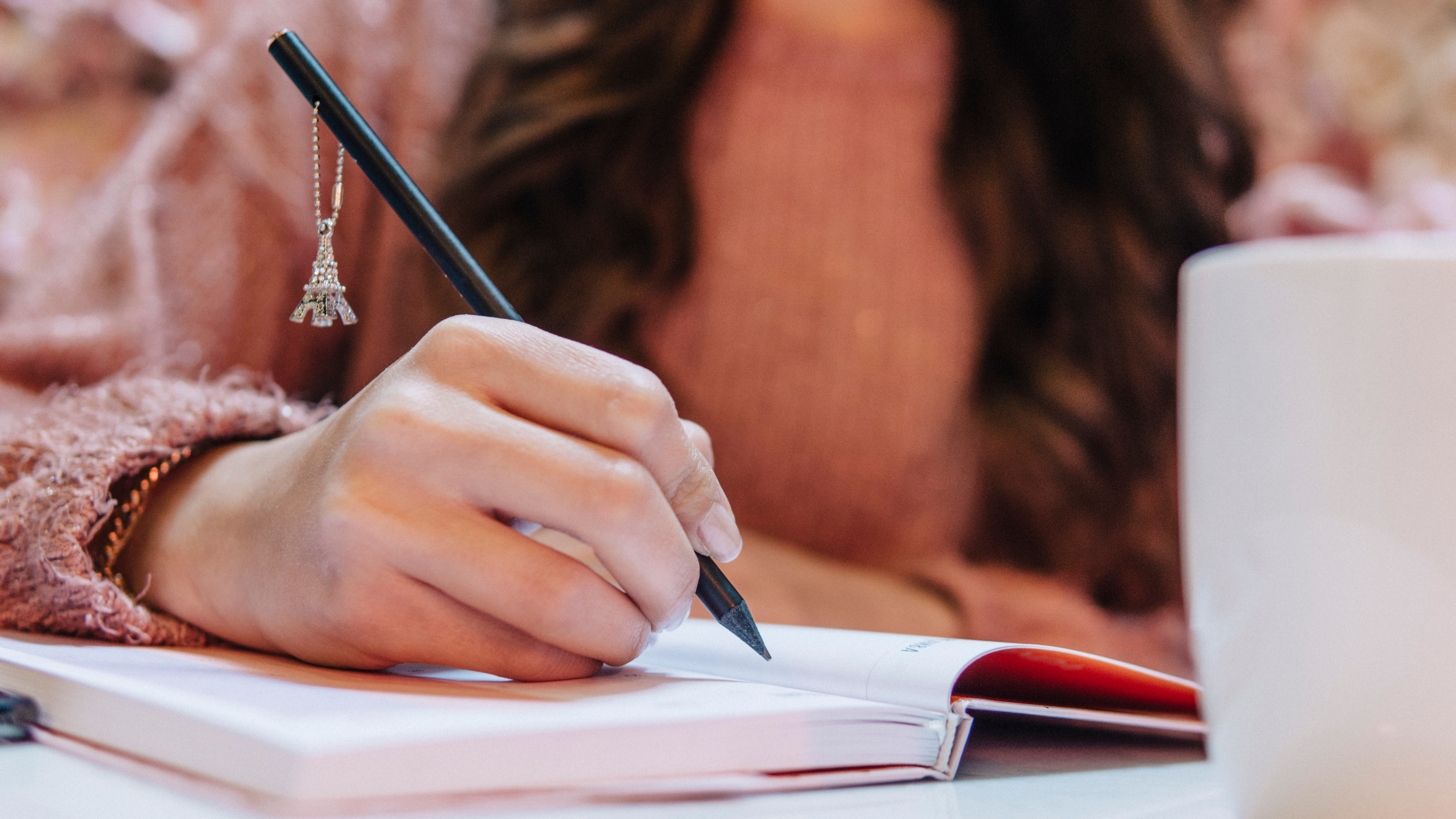 student writing in notebook