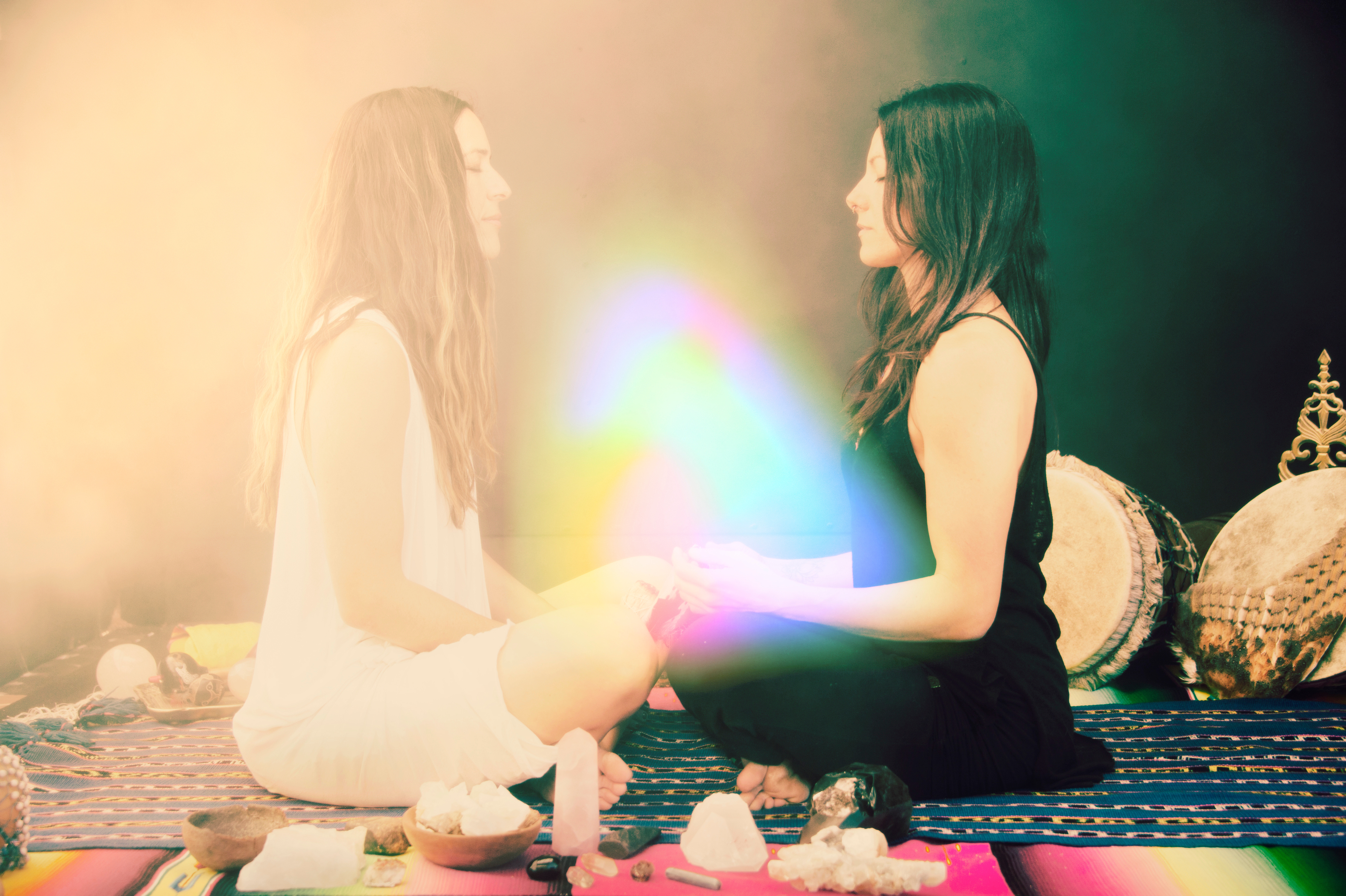 2 women holding hands with crystals, energy healing