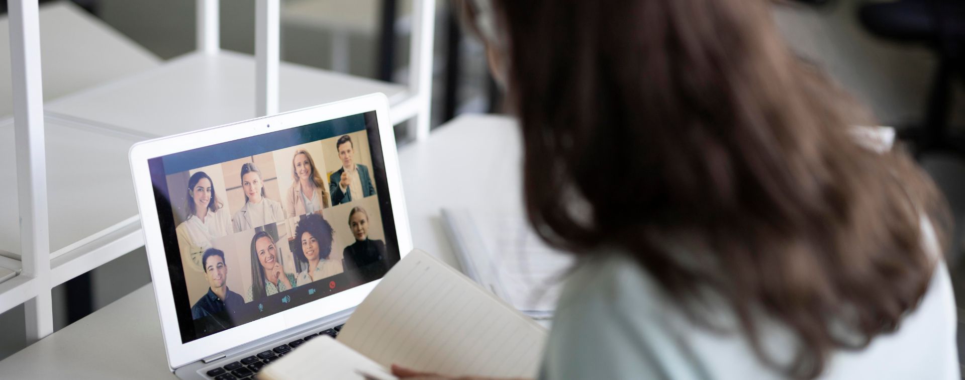 WOman at desk in virtual meeting