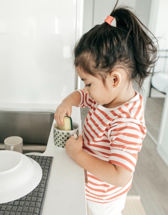 small child cleaning