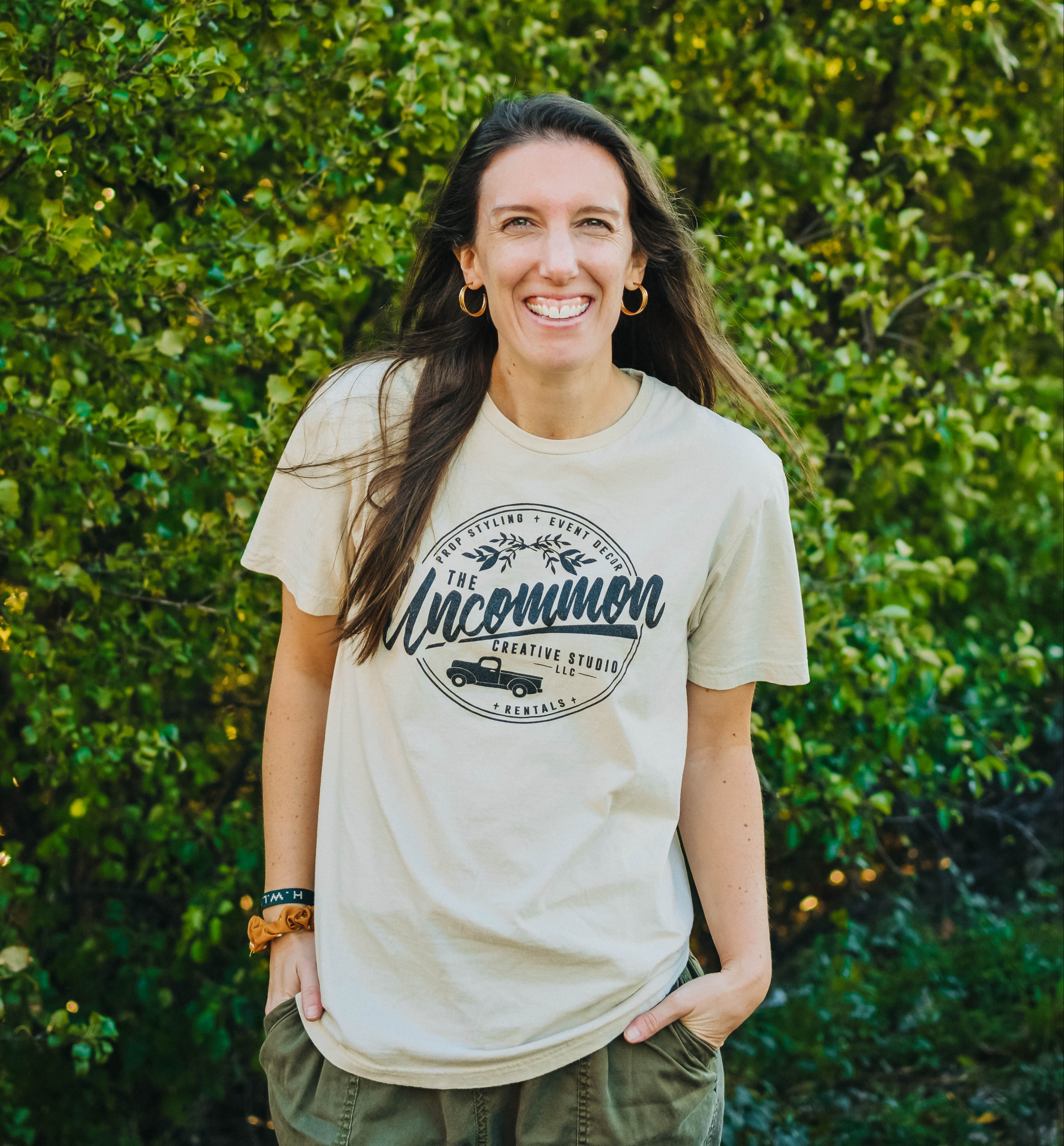 Katie Driver, instructor of Host + Gather in front of greenery