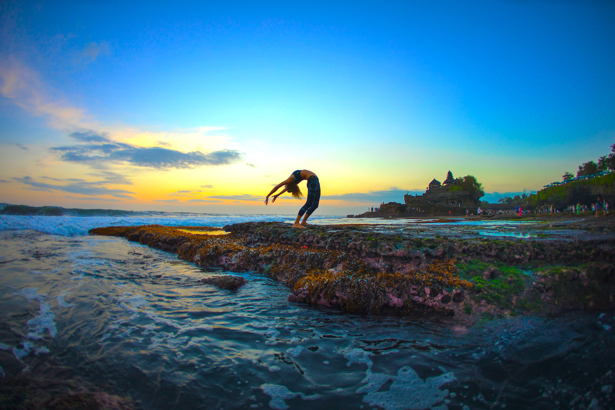 Yoga teacher Bex Tyrer in backbend by the sea in Bali