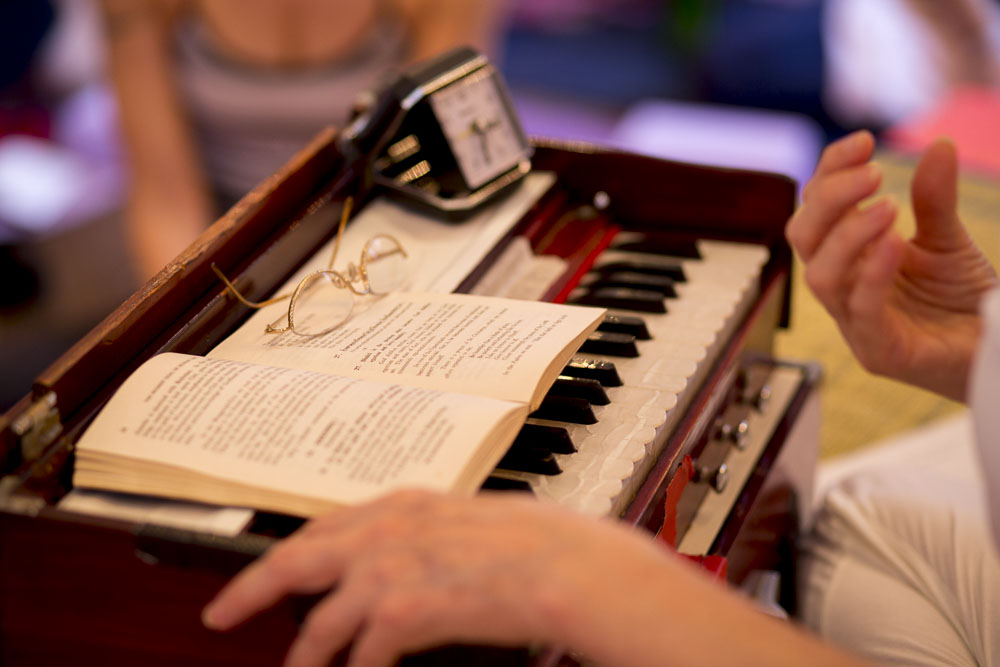 Harmonium with a book and reading glasses resting on top