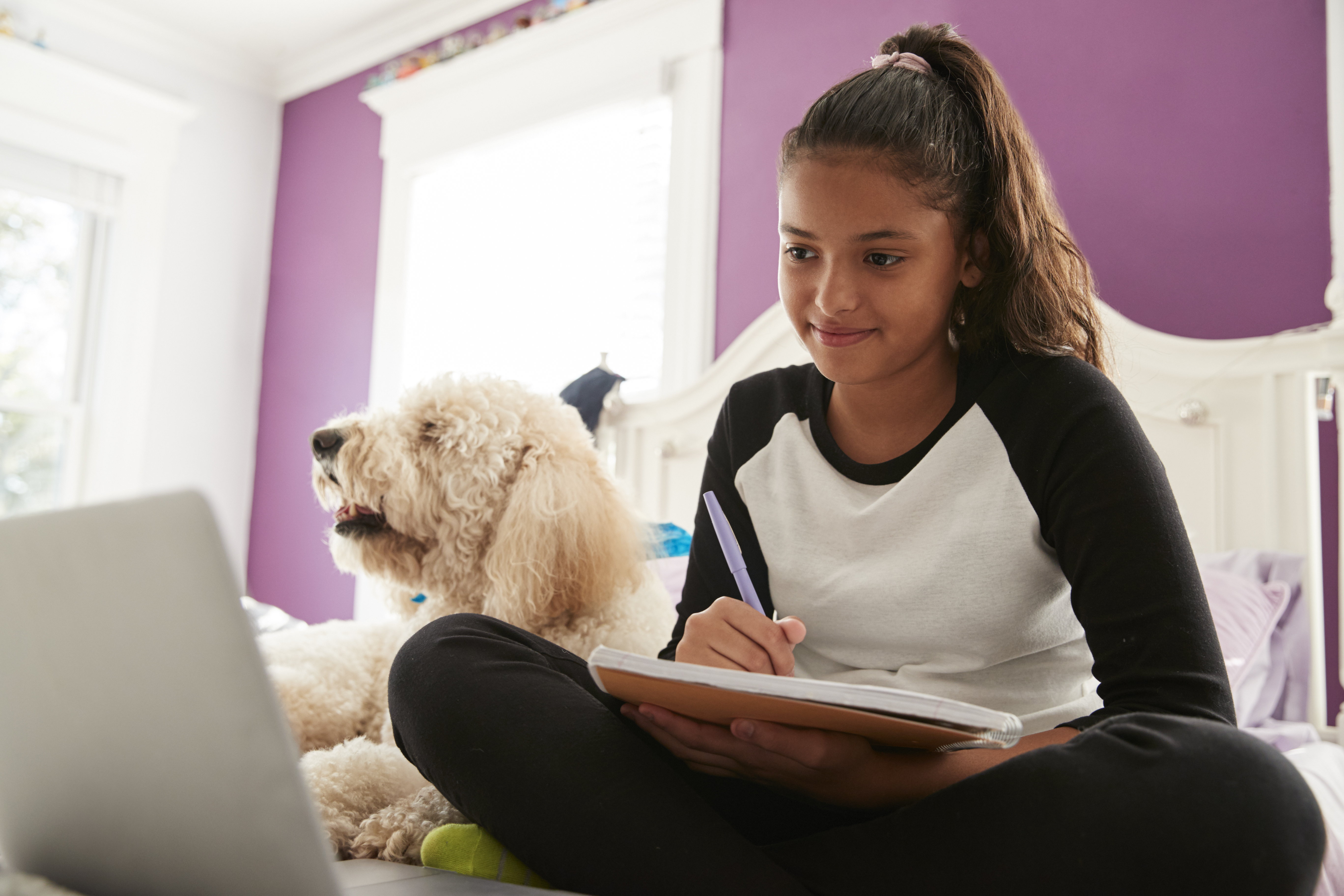 Teen sitting on bed