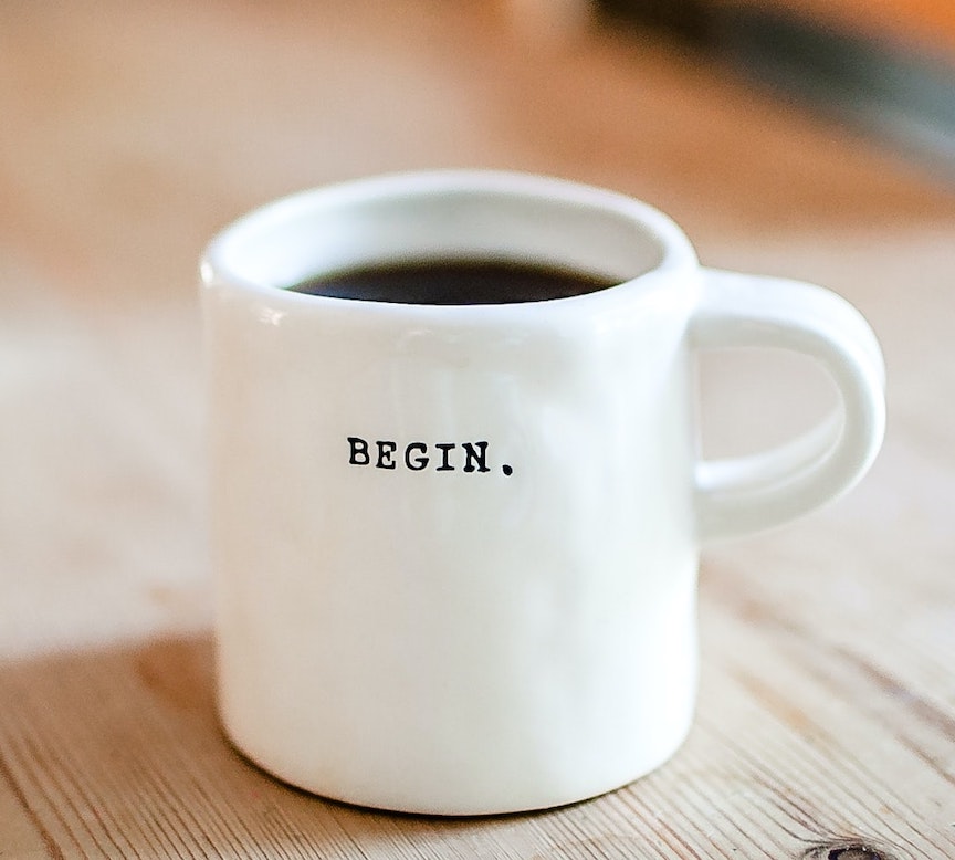 Coffee cup with the word begin