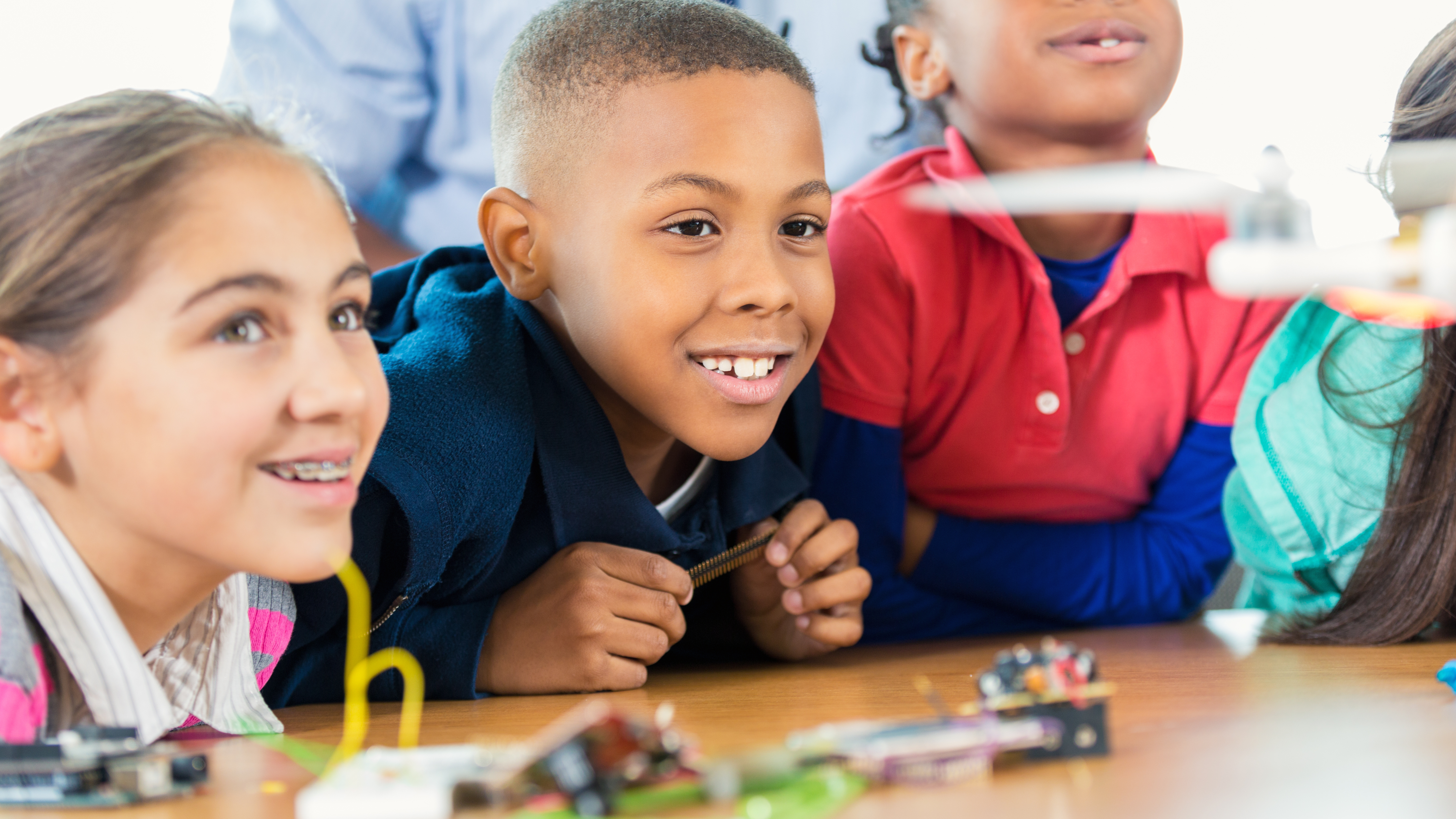 kids looking excitedly at science materials