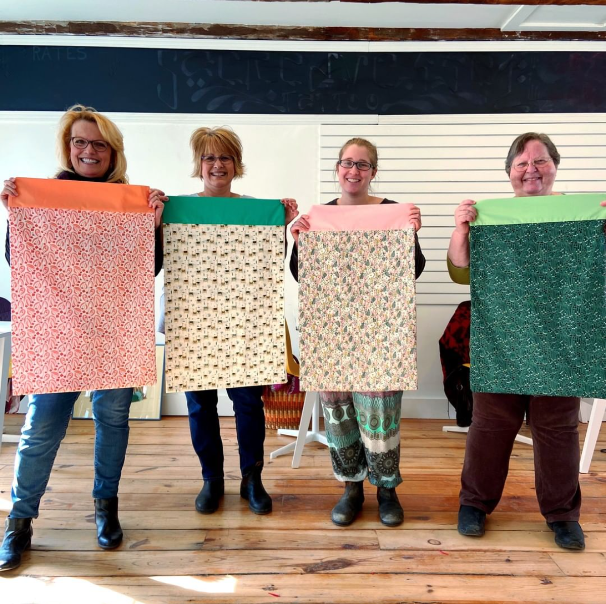 Group holding pillowcases they made