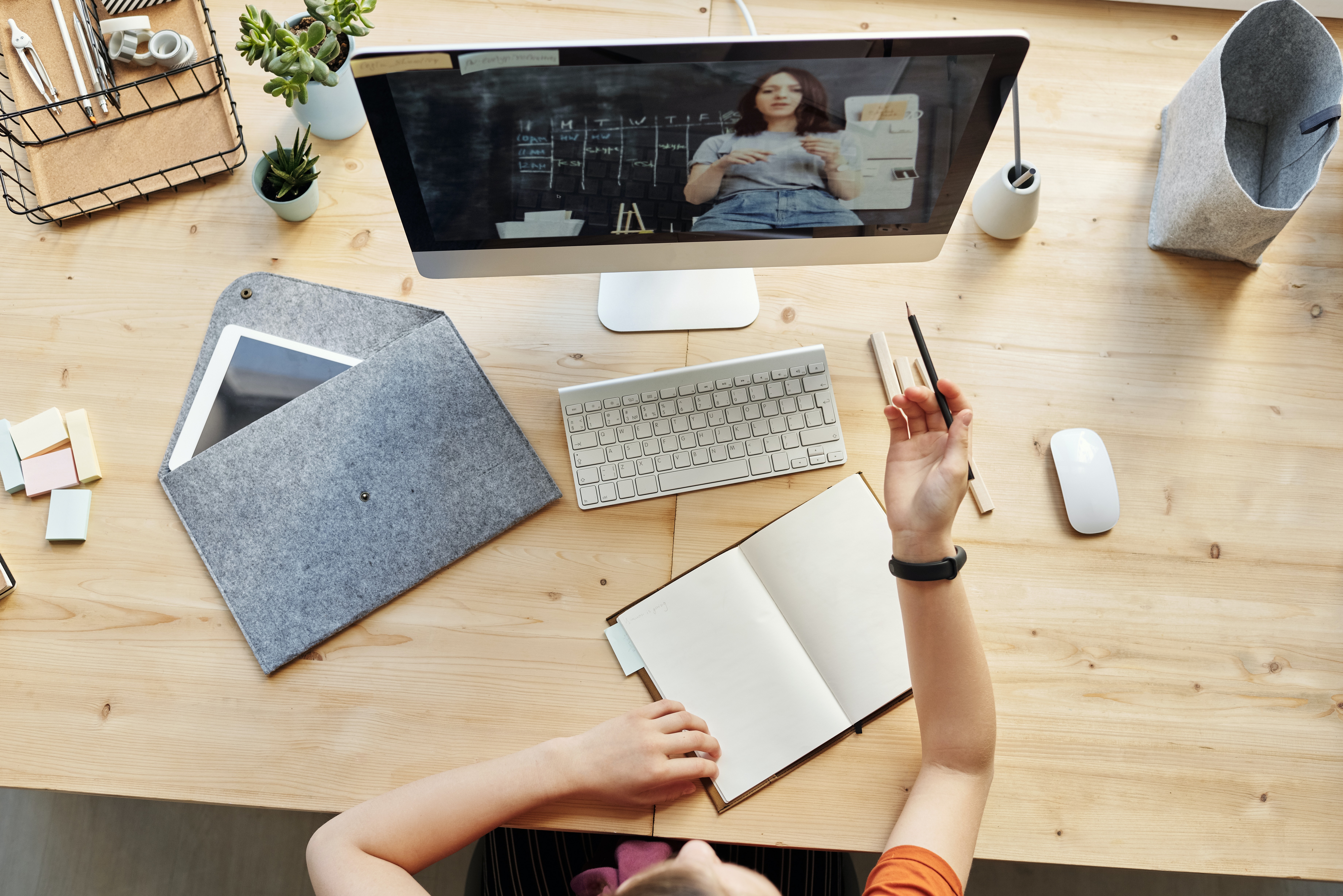 video conference on computer with notebook open