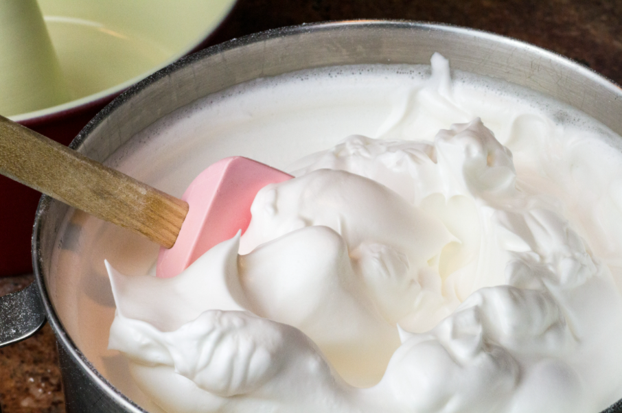 A bowl of merengued egg whites is on display.