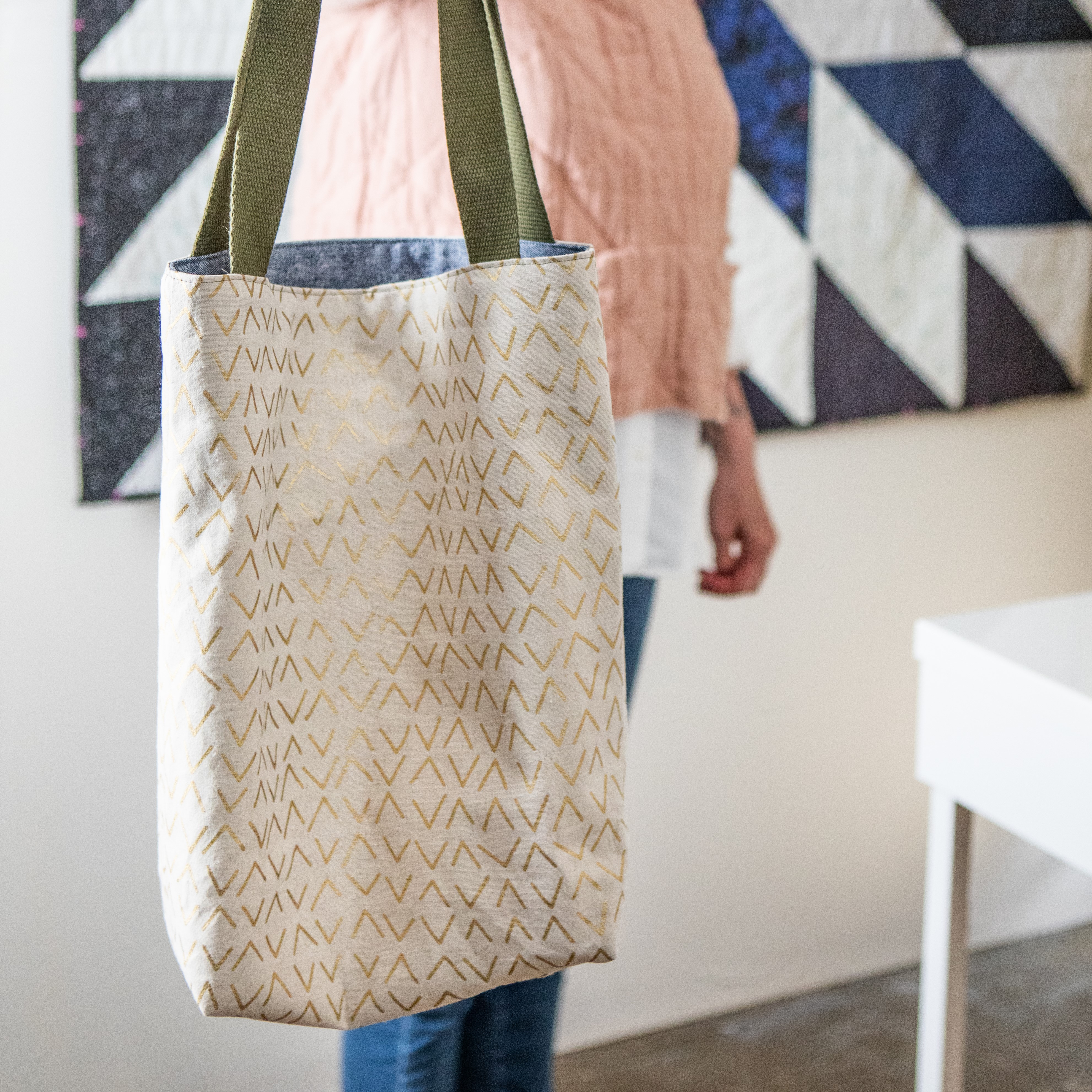 A photo of a tote bag being held out to the camera