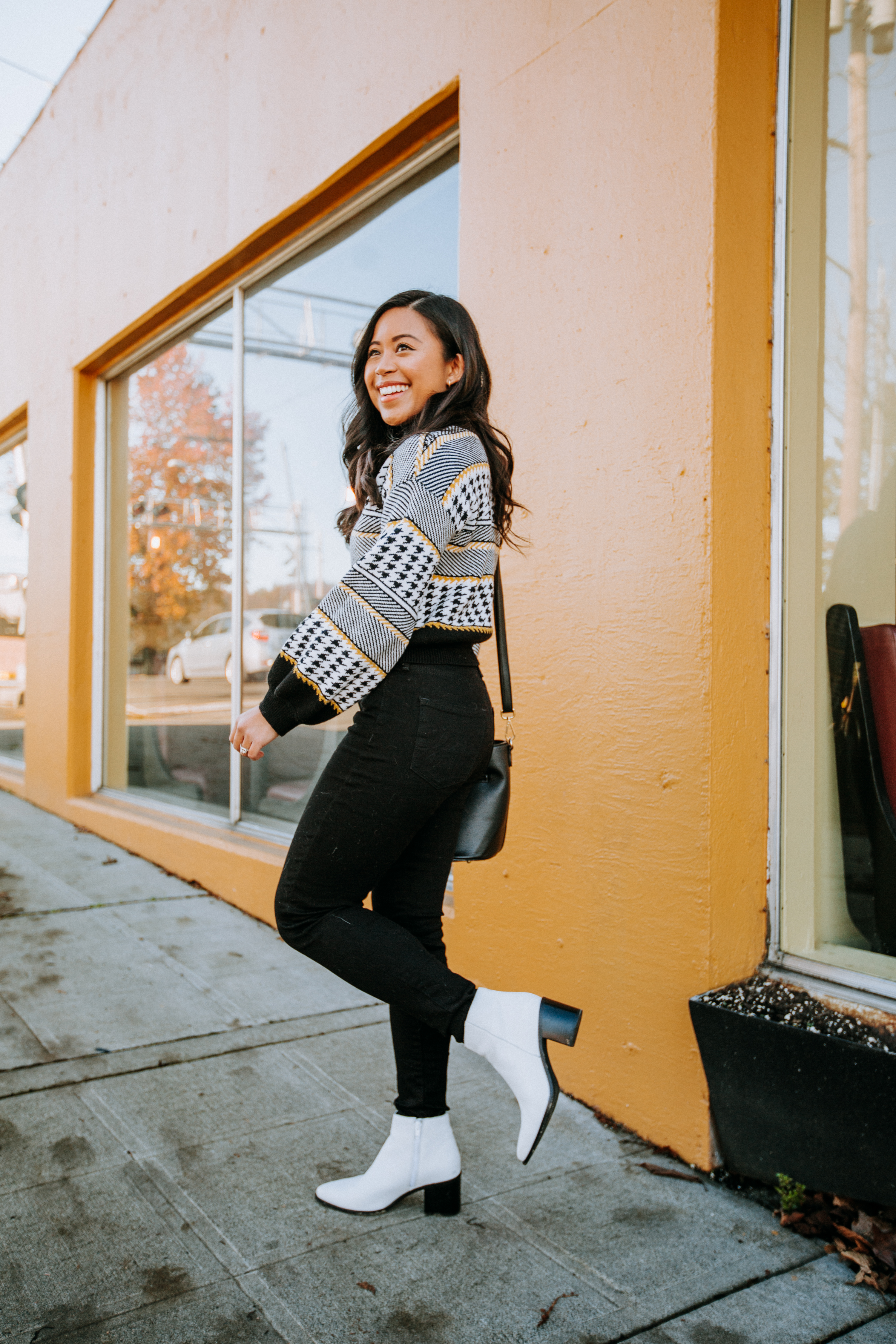 Emma Cortes - standing in front of yellow wall