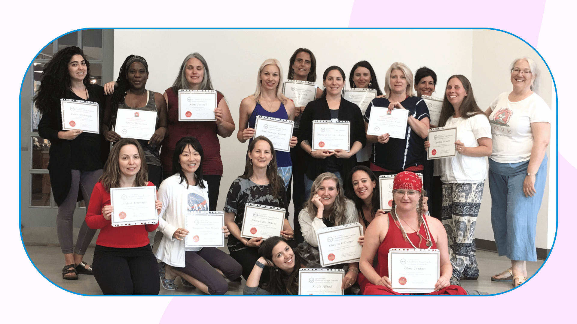 A group of 17 people proudly hold their certificates from the kids yoga teacher training.