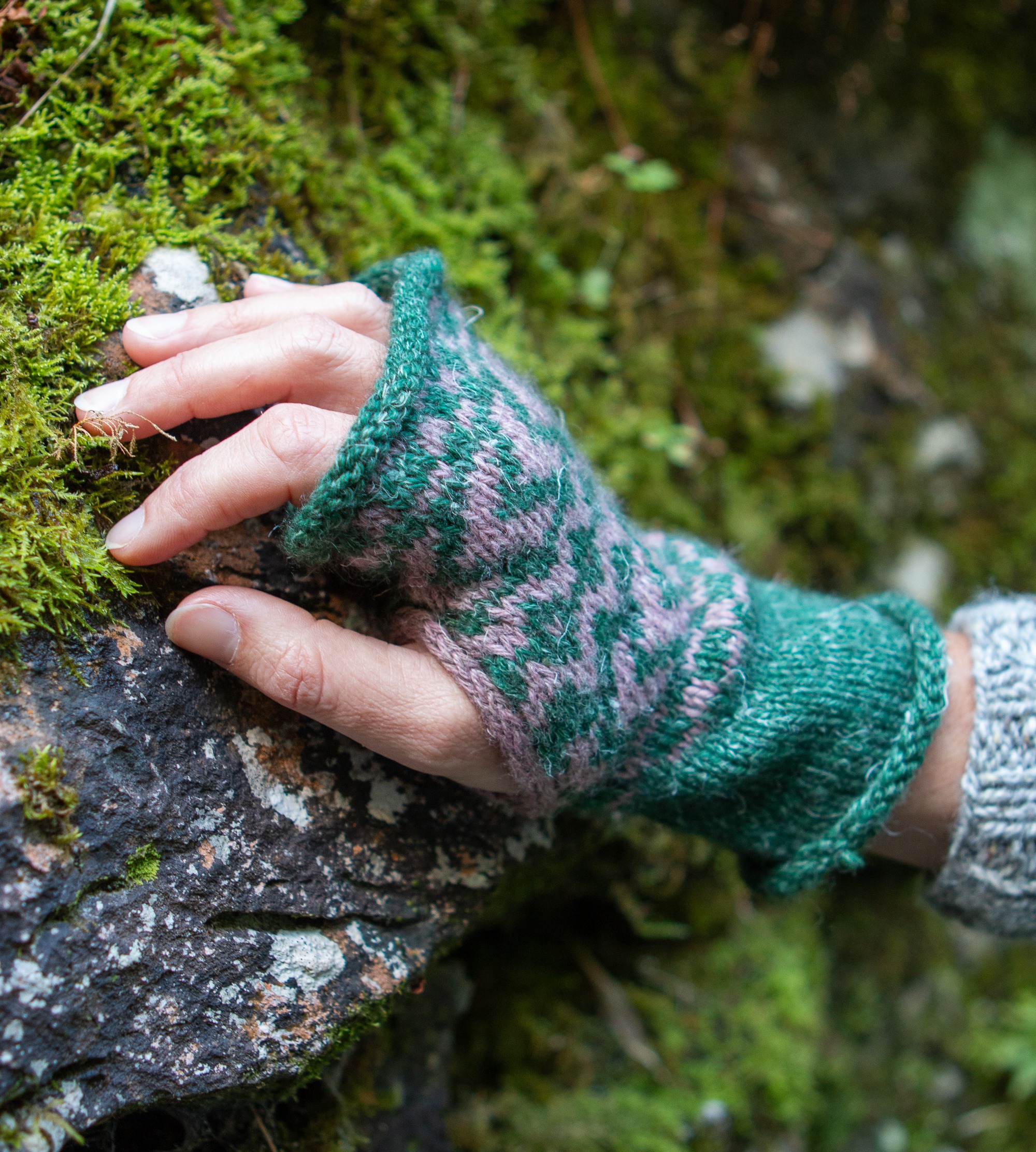 Close up of a colourwork mitten on a hand.