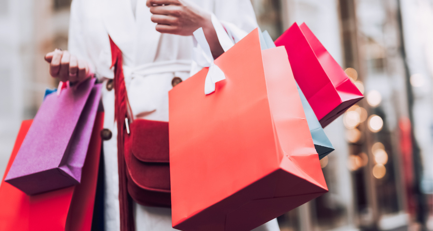 woman with several brightly colored shopping bags