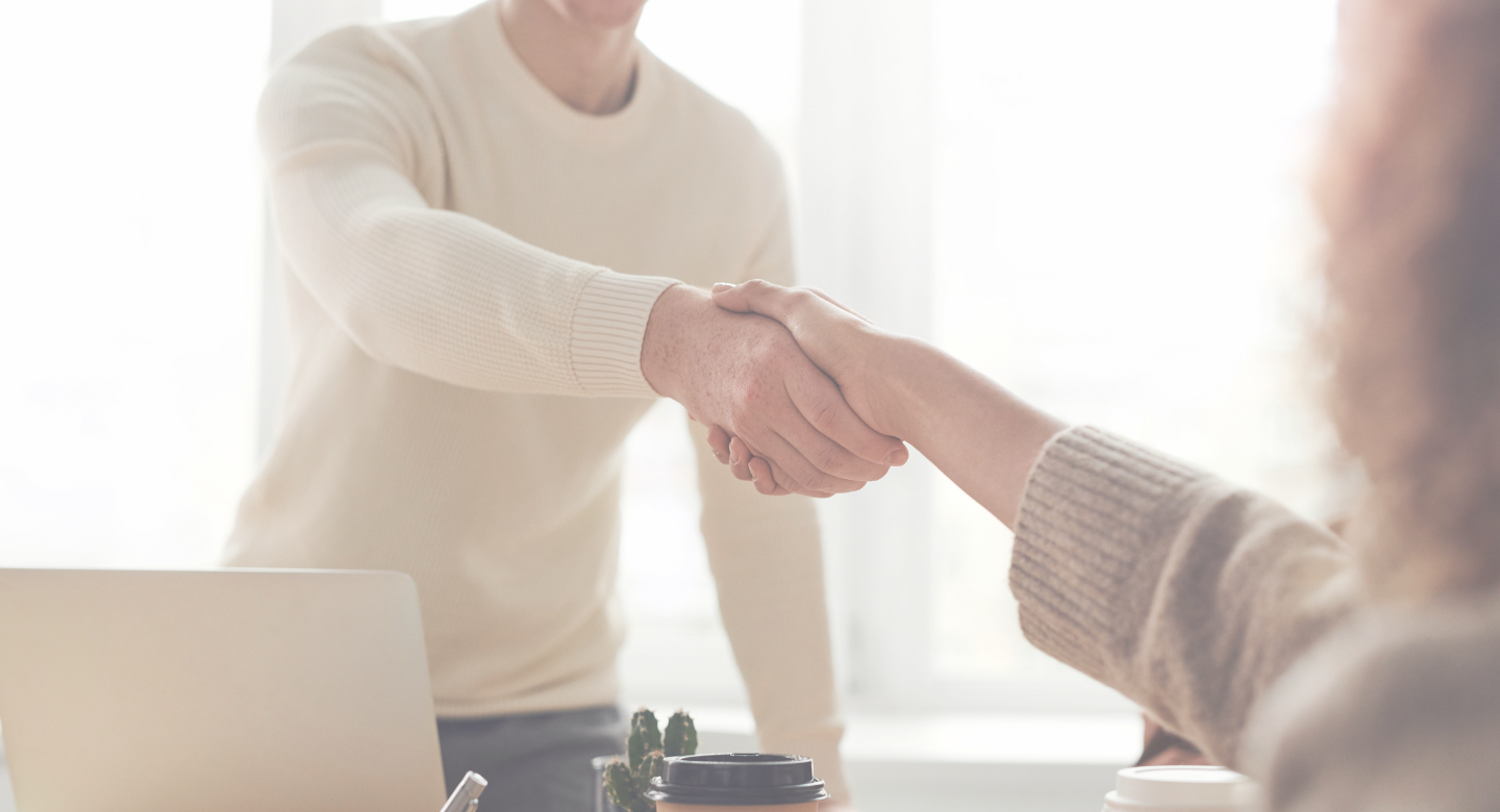 Background image of two people shaking hands