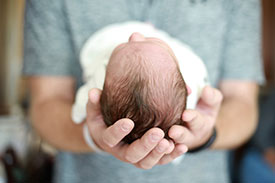 Infant being held by chiropractor