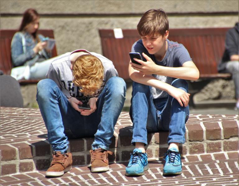Boys looking at their phones