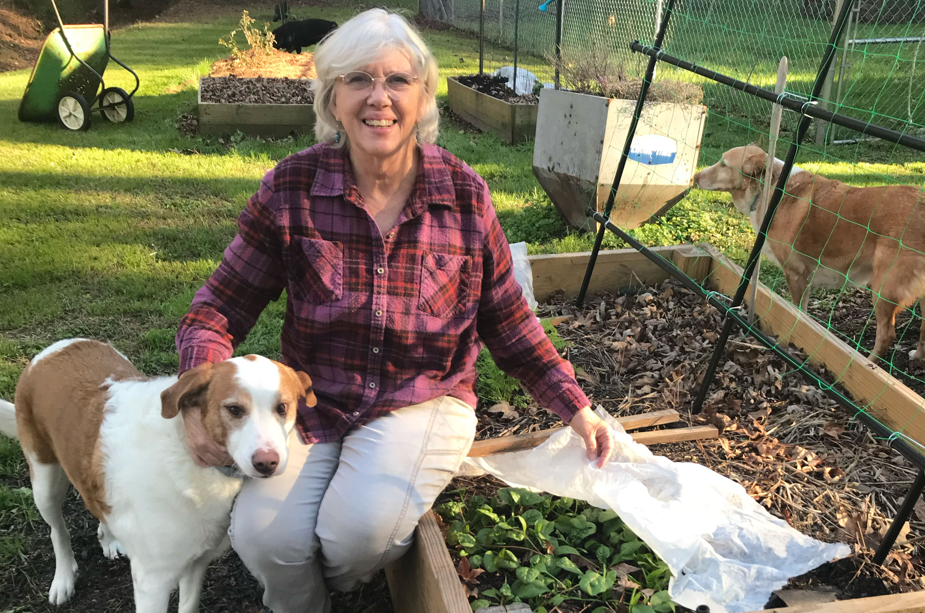 Karen Creel with cute dog in the garden