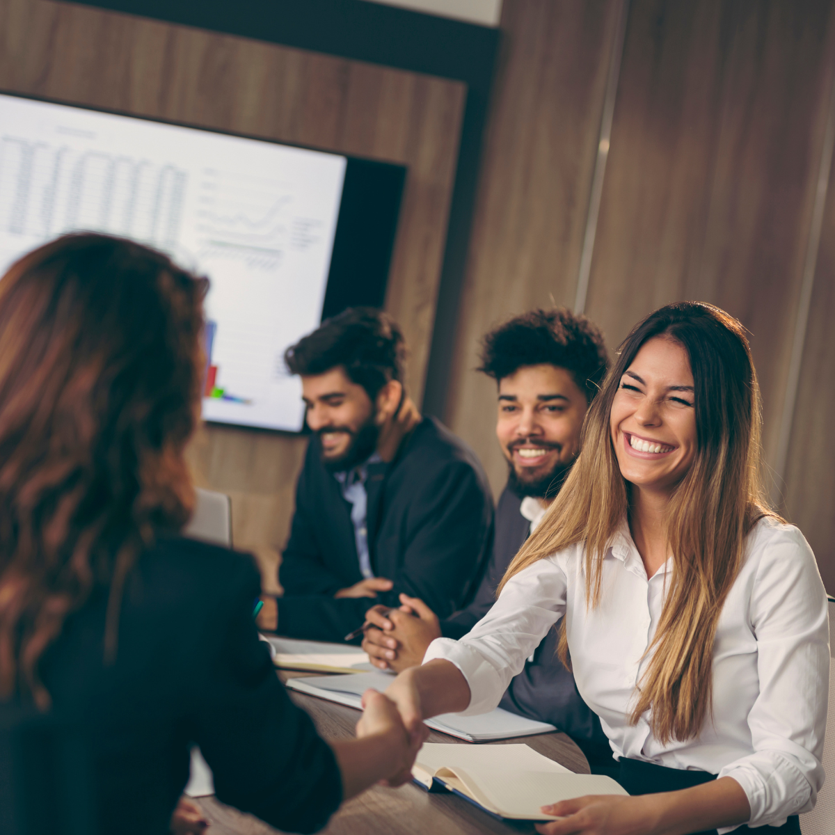 Women shaking hands in a meeting