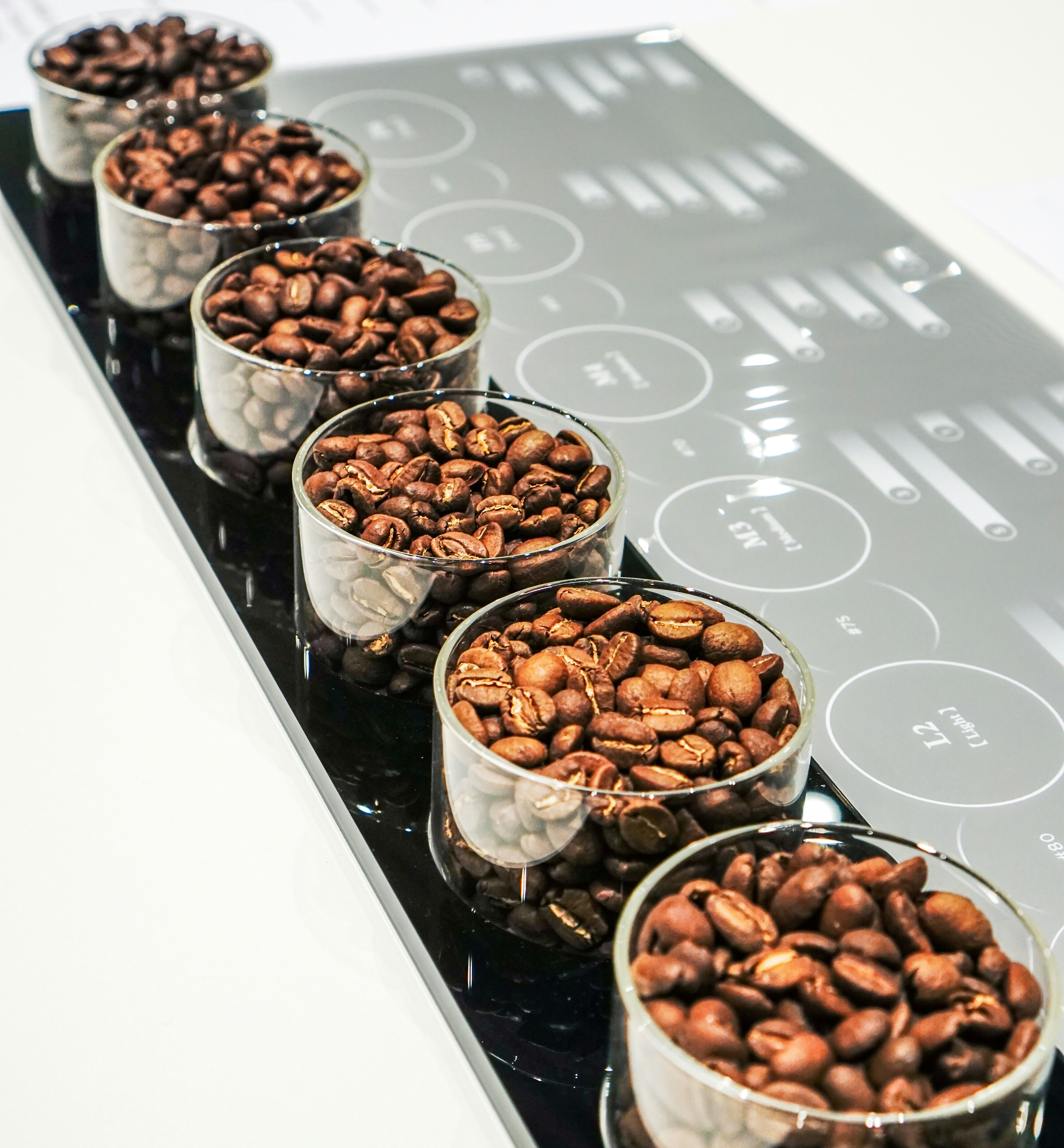 small glass bowls with roasted coffee beans