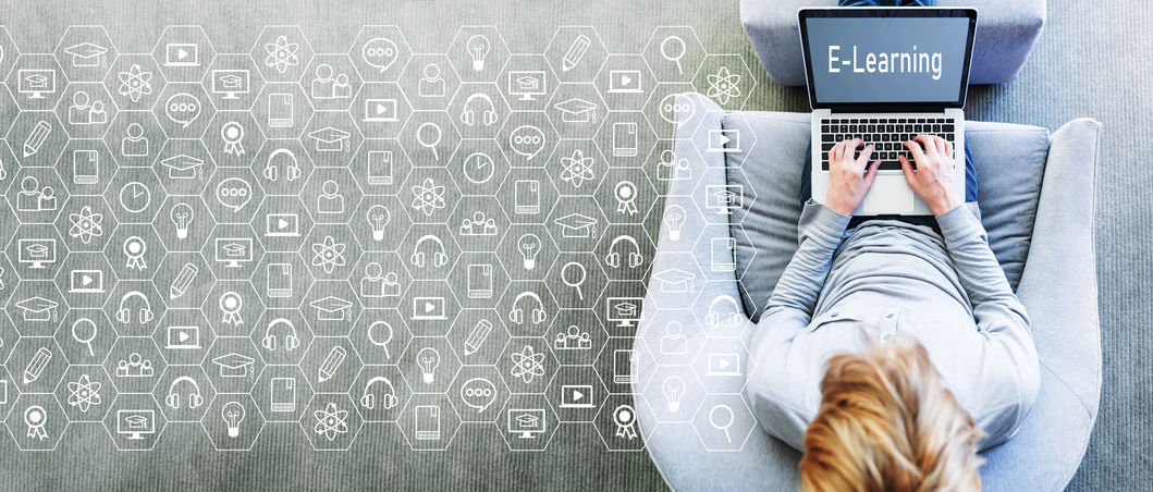 ceiling down view of woman seated on chair typing on laptop