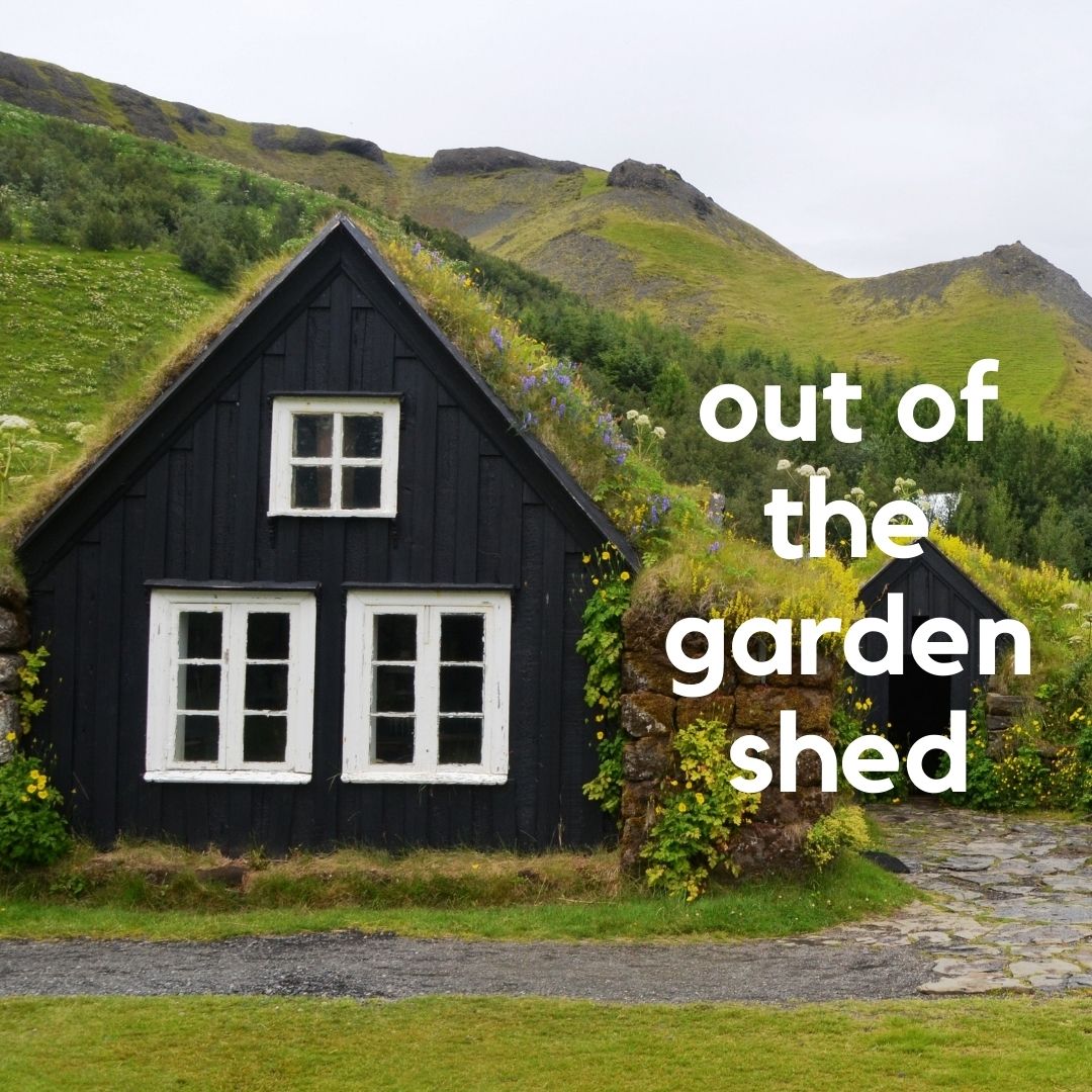Image of a brown wooden cottage with a green growing roof that blends into the green hills behind it with white text that reads "out of the garden shed."