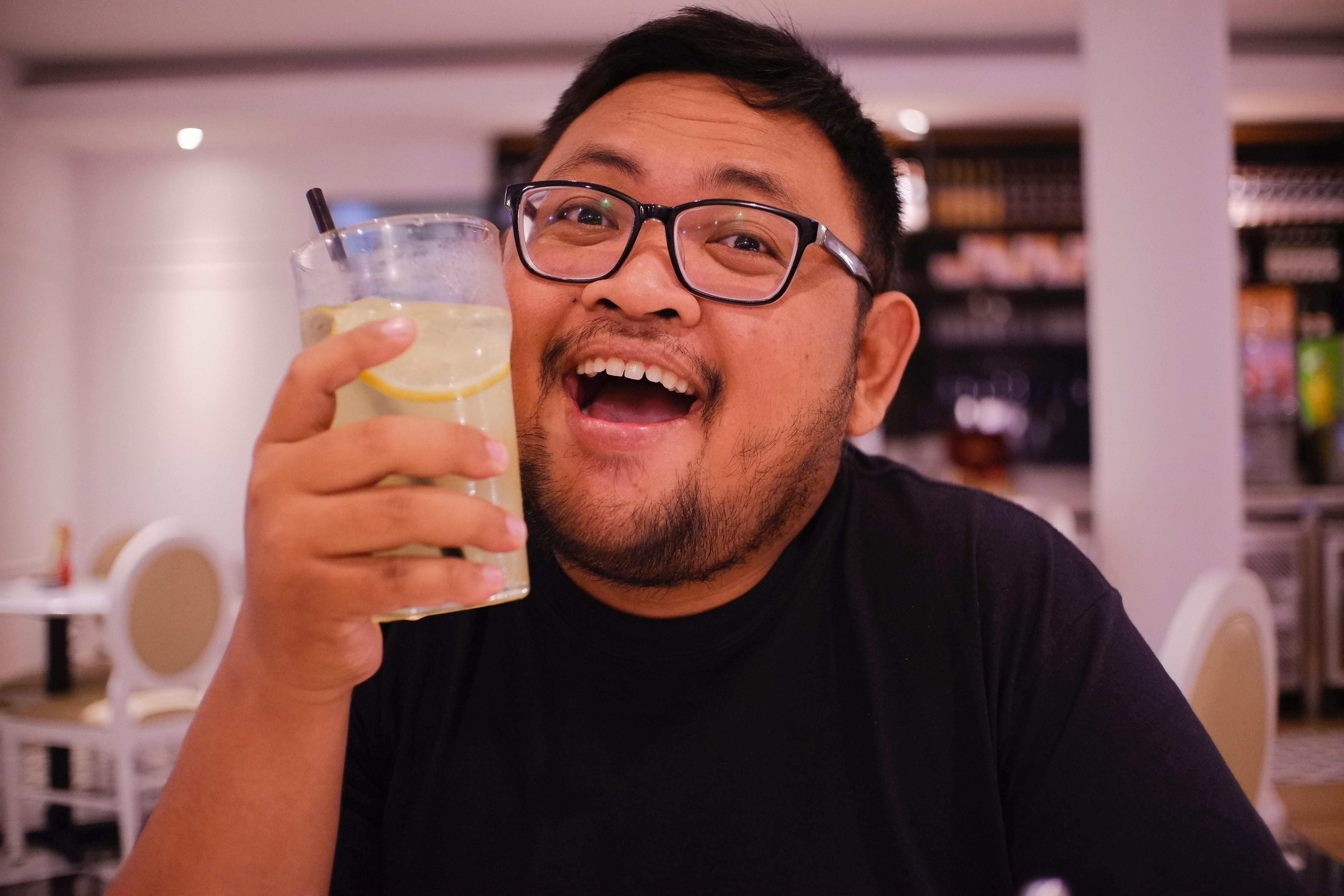 Smiling man holding a drink